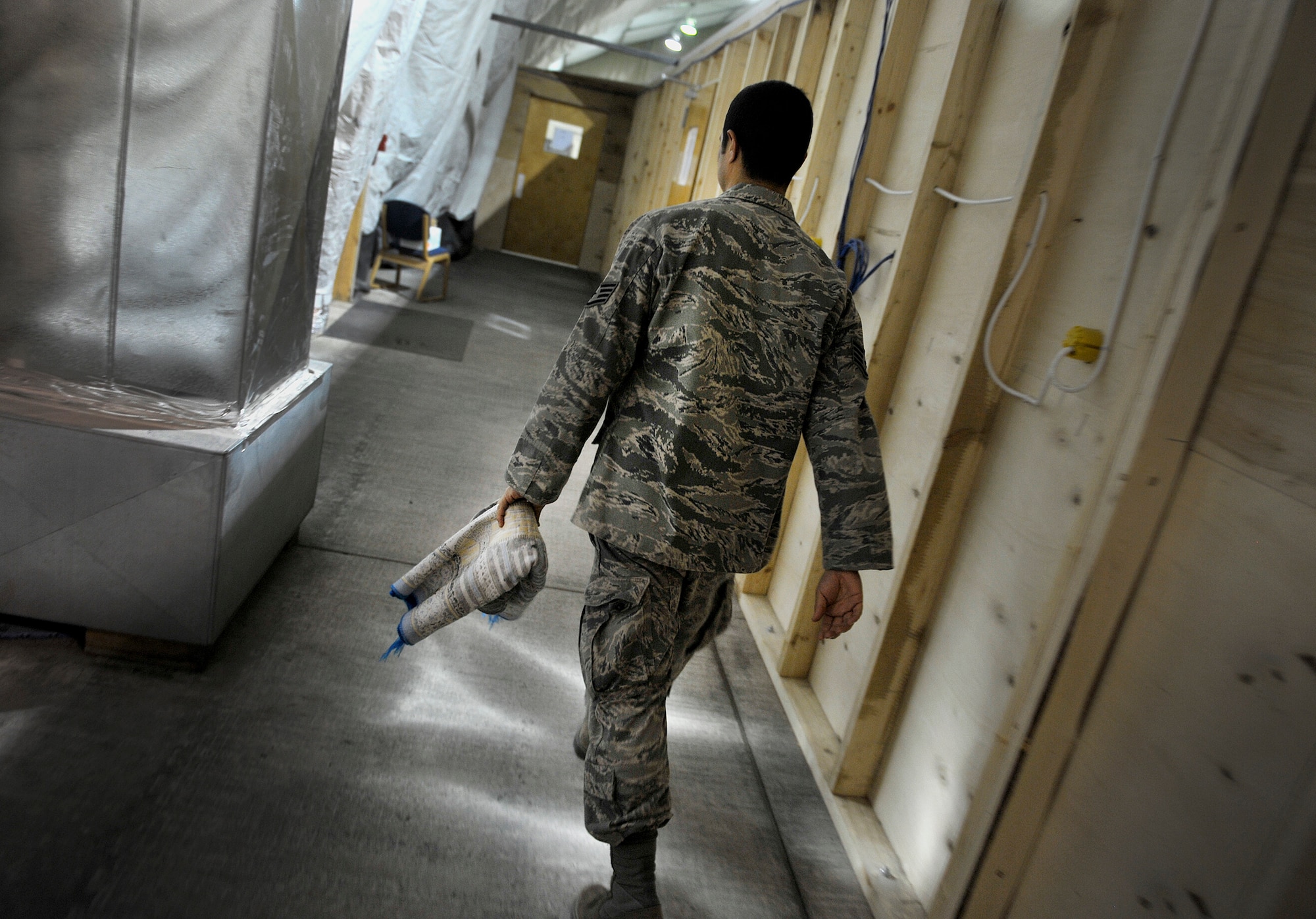 U.S. Air Force Staff Sgt. Edger Gaitan, Passenger Service NCOIC, 376th Expeditionary Logistics Readiness Squadron, makes his way toward the distinguished visitor suite where he prays during his shift at the Passenger Terminal, Transit Center at Manas, Kyrgyzstan, Sept. 19, 2012. Gaitan spends his graveyard shift making sure deploying and redeploying U.S. and coalition members are transported properly. Gaitan is a devout Muslim who finds the time to pray daily in between mission requirements here at Manas. Gaitan has had the priveledge of serving his country while helping to mentor those around him with his strong personal values and religious beliefs. (U.S. Air Force photo/Staff Sgt. Clay Lancaster)
