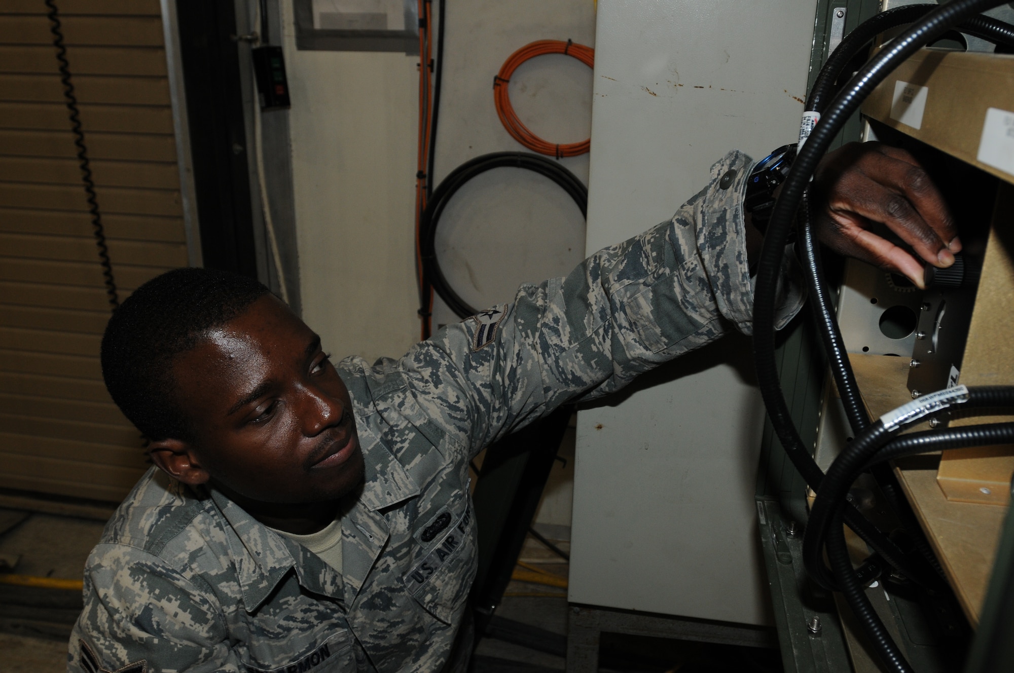 SOUTHWEST ASIA - U.S. Air Force Airman 1st Class Jamal Spearmon, 380th Expeditionary Aircraft Maintenance Squadron Global Hawk ground communications specialist, checks notch filters for the communication links to an RQ-4 Global Hawk Launch Recovery Element shelter Oct. 10, 2012. Spearmon, a Washington, D.C., native, is deployed from Beale Air Force Base, Calif. (U.S. Air Force photo/Tech. Sgt. Amanda Savannah)