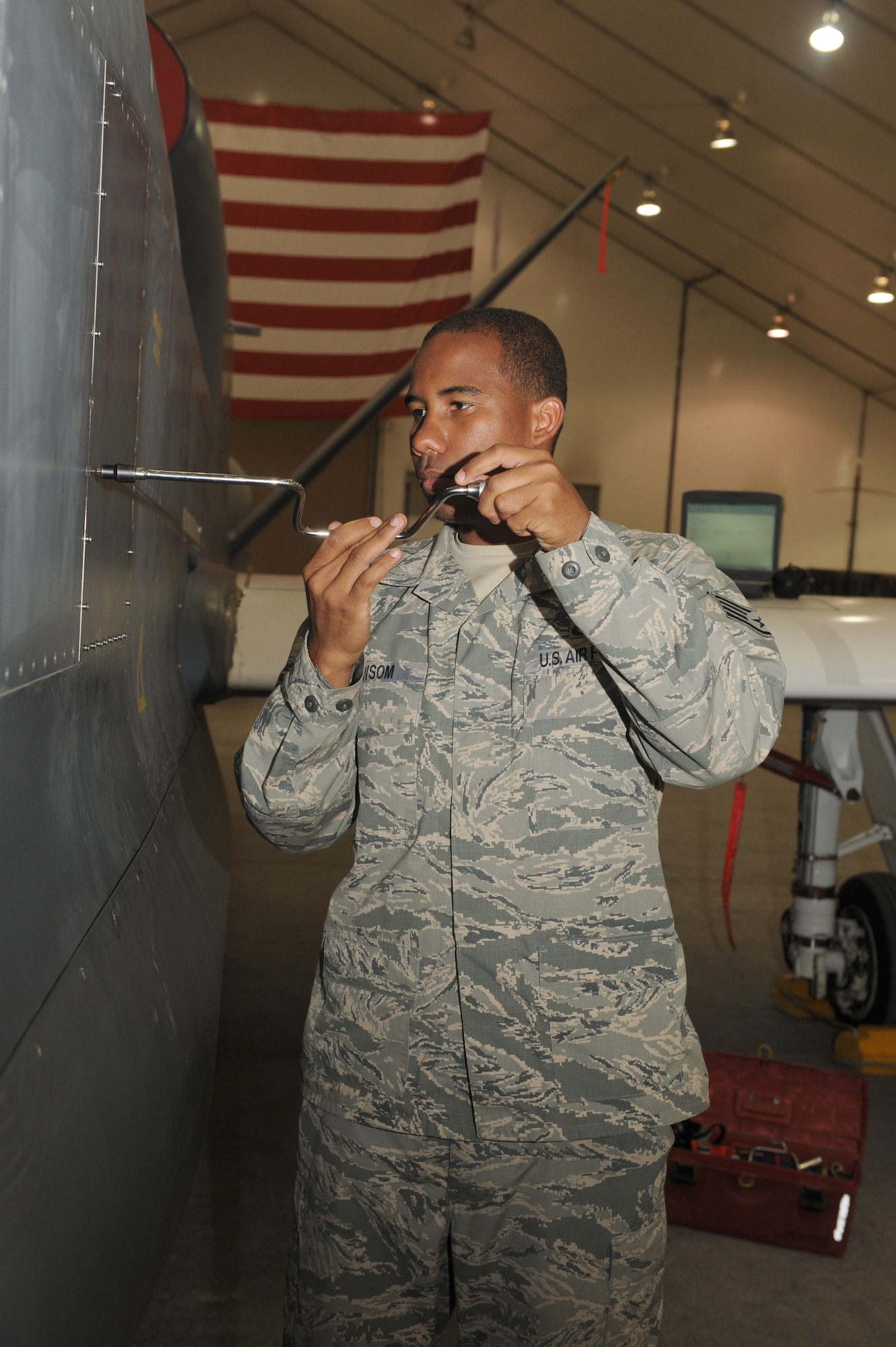 SOUTHWEST ASIA - U.S. Air Force Staff Sgt. Michael Newsom, 380th Expeditionary Aircraft Maintenance Squadron Global Hawk crew chief, loosens the screws of a panel on the RQ-4 Global Hawk before performing maintenance on the aircraft Oct. 10, 2012. Newsom, a Miami, Fla., native, is deployed from Grand Forks Air Force Base, N.D. (U.S. Air Force photo/Master Sgt. Scott MacKay)