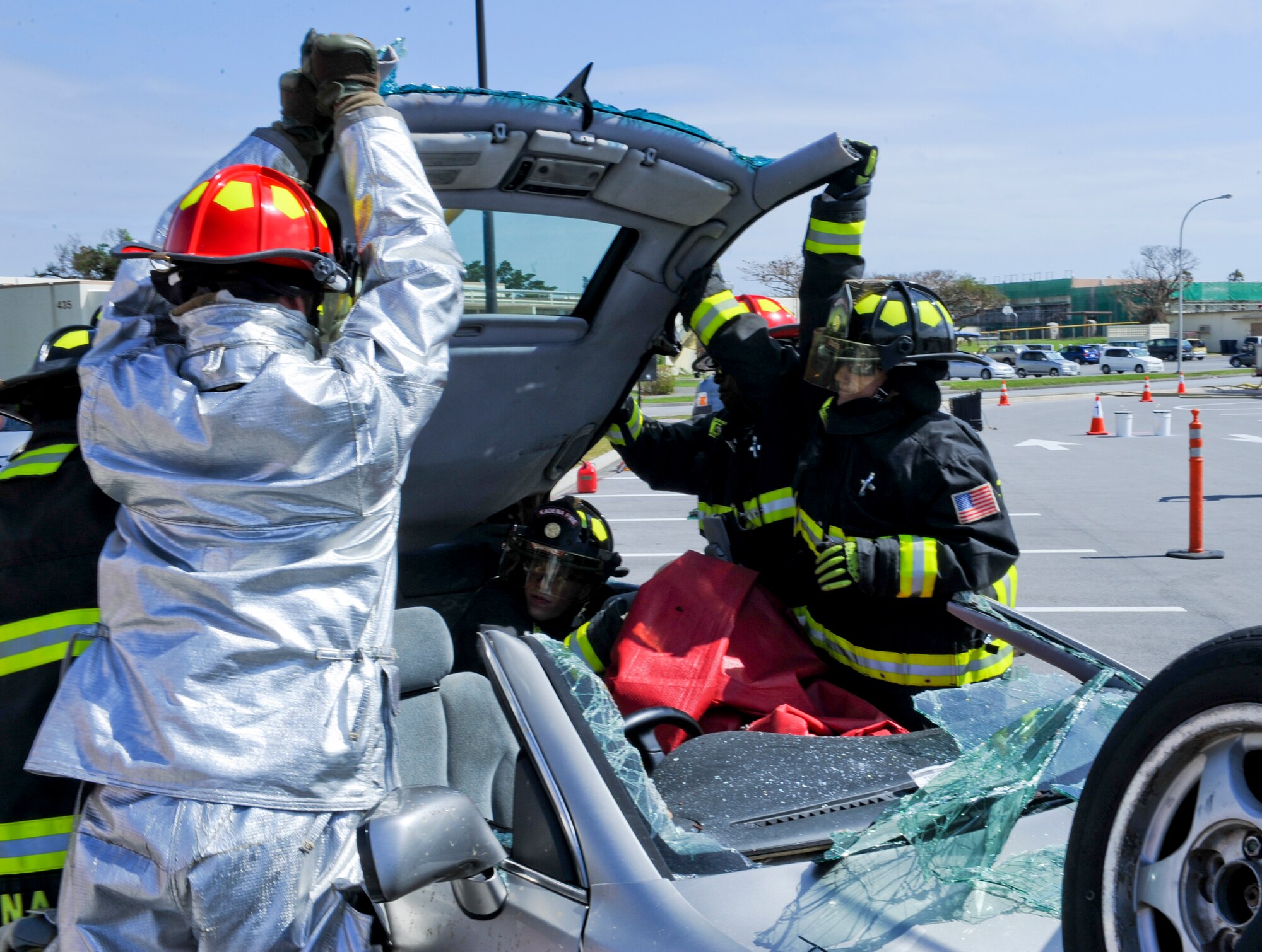 Firefighters from the 18th Civil Engineer Group lift a roof off of a car to get to a casualty during a vehicle extrication demonstration on Kadena Air Base, Japan, Oct. 12, 2012. Vehicle extrication is the process of removing a vehicle from around a person who has been involved in a motor vehicle accident when conventional means of exit are inadvisable.  (U.S. Air Force photo/Airman 1st Class Justin Veazie)