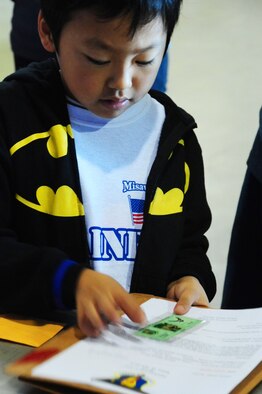 Children process through a deployment line during Operation Children on Deployment Exercise at Misawa Air Base, Japan, Oct. 8, 2012.  The Airman and Family Readiness Center hosts Operation CODE annually, which gives military dependants a chance to march in their parents’ boots.  (U.S. Air Force photo by Staff Sgt. April Quintanilla)