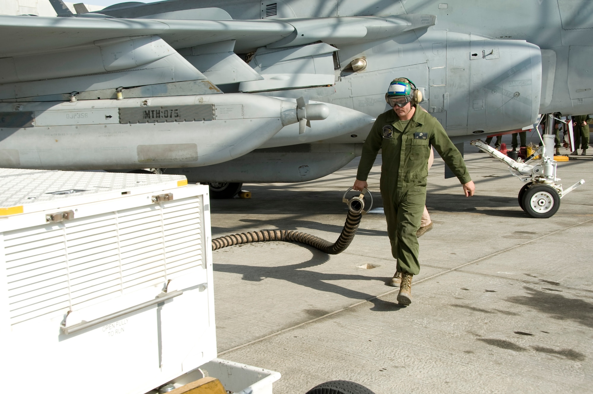 Lance Cpl. Sean Hampe, Marine Tactical Electronic Warfare Squadron 3 ejection seat technician, disconnects the pneumatic air starter during the launch of an EA-6B Prowler Oct. 8, 2012 in Southwest Asia. VMAQ-3 Marines provide electronic warfare support to coalition forces and the Marine Air Ground Task Forces. All four of the Marine Corps’ Tactical Electronic Attack squadrons are based at Marine Corps Air Station Cherry Point, N.C. (U.S. Air Force photo/Senior Airman Bryan Swink)