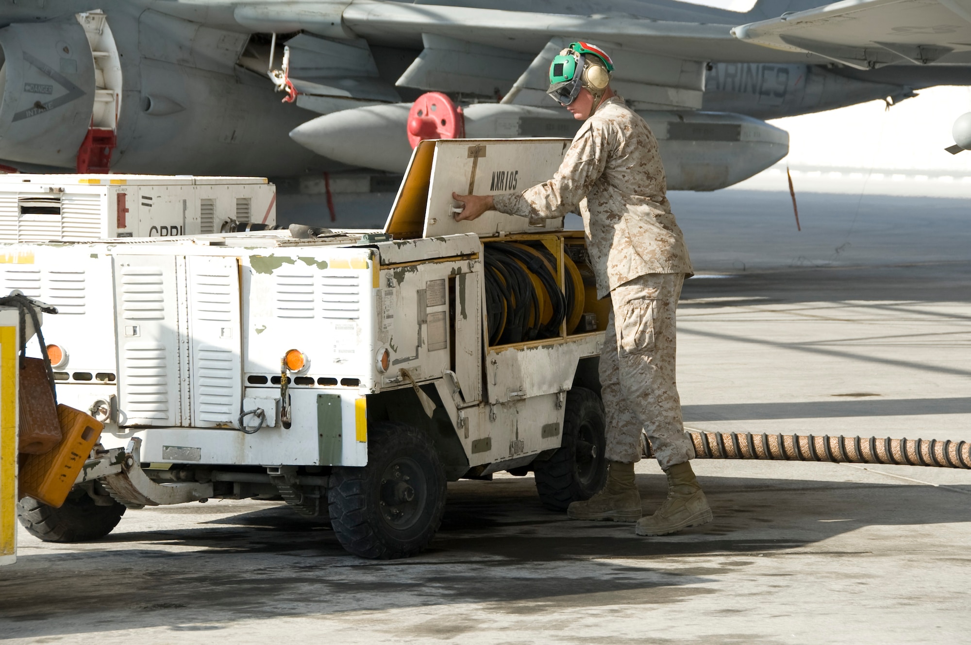 Lance Cpl. Matthew Watson, Marine Tactical Electronic Warfare Squadron 3 electronic countermeasures technician, secures an electrical power cart during the launch of an EA-6B Prowler Oct. 8, 2013 in Southwest Asia. The VMAQ-3 “MoonDogs” arrived here Sept. 25, in order to relieve the VMAQ-2 “Death Jesters.” All four of the Marine Corps’ Tactical Electronic Attack squadrons are based at Marine Corps Air Station Cherry Point, N.C. (U.S. Air Force photo/Senior Airman Bryan Swink)