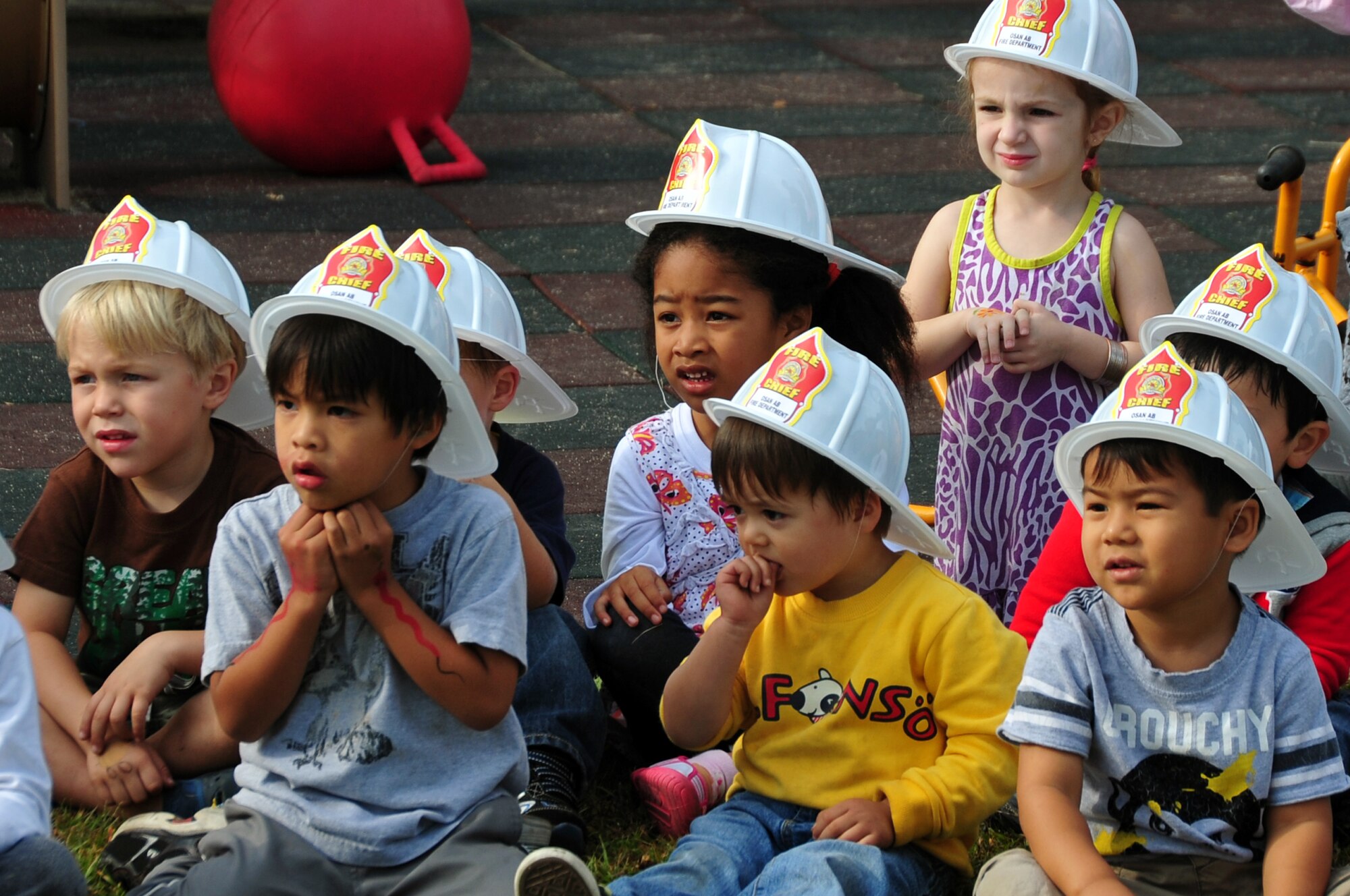 Children at the child development center watch as firefighters explain the importance of fire safety during Fire Prevention Week at Osan Air Base, Republic of Korea, Oct. 9, 2012. The 51st Civil Engineer Squadron firefighters recognize Fire Prevention Week and support the nationwide theme developed by the National Fire Protection Association. (U.S. Air Force photo/Staff Sgt. Craig Cisek)