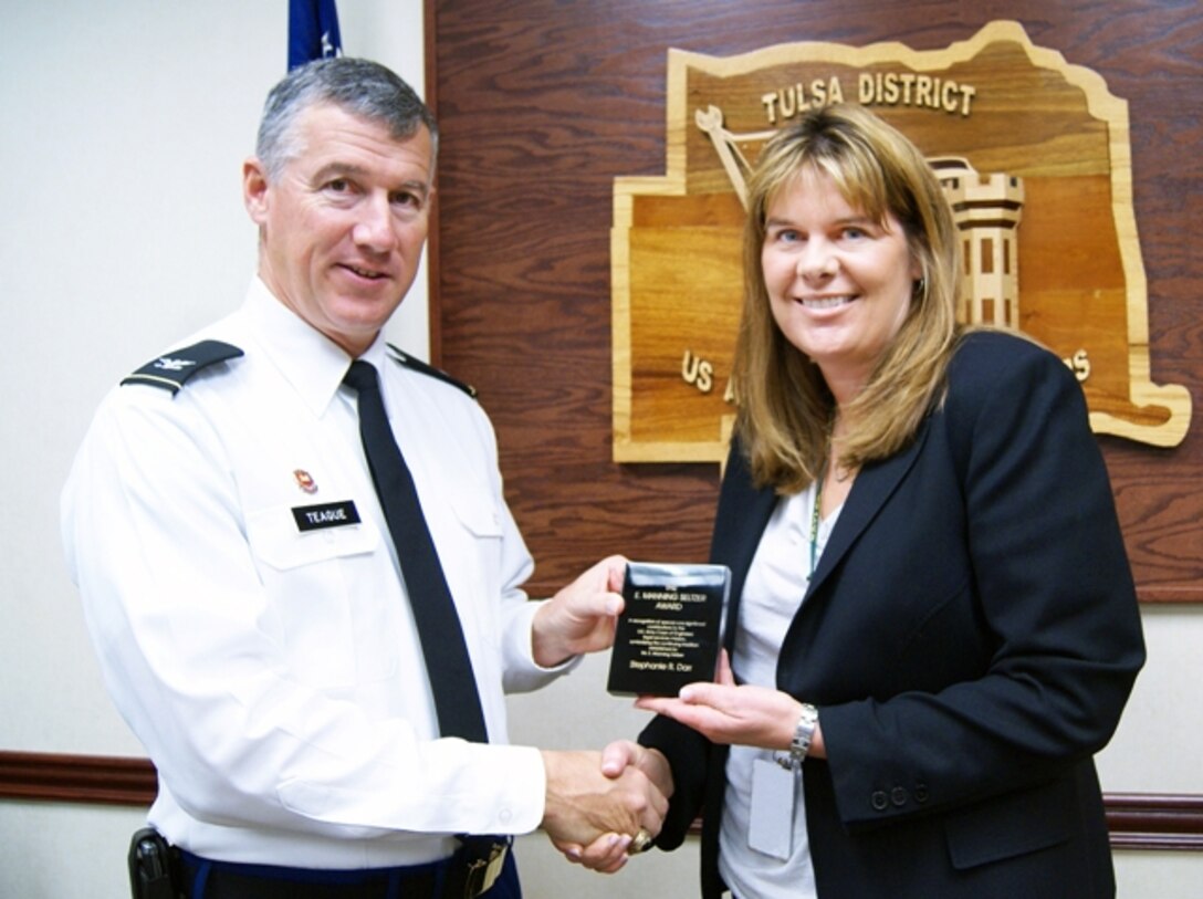 Tulsa District U.S. Army Corps of Engineers attorney Stephanie R. Darr, the district's labor counselor, is presented the E. Manning Seltzer Award by District Commander Col. Michael Teague. The award recognizes a Corps attorney who has made one or more special contributions to the Corps’ legal services mission. The contribution may result from the development of a legal theory or application in any field of law, legal management innovation or practice, or outstanding performance in solving a legal or management problem.