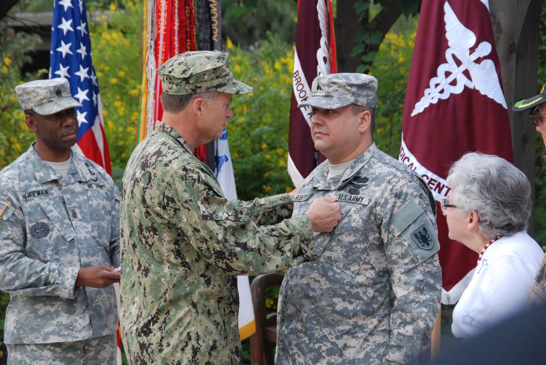 Navy Adm. James A. Winnefeld Jr., pins the Purple Heart medal on Army Sgt. Paul Roberts during a ceremony at the Warrior and Family Support Center on Fort Sam Houston in San Antonio, Oct. 12, 2012.  U.S. Army photo by Robert Shields
