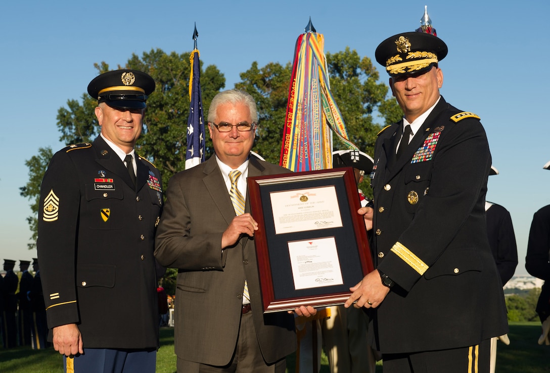 Army Chief of Staff Gen. Ray Odierno, left, and Sgt. Maj. of the Army Raymond F. Chandler III present the Outstanding Civilian Service Award to Mike Conklin during a ceremony in Joint Base Myer-Henderson Hall, Va., Oct. 11, 2012. Conklin received the award for his outstanding service to the Army, disabled veterans and their families. He is the chairman and CEO of the Sentinels of Freedom scholarship foundation.