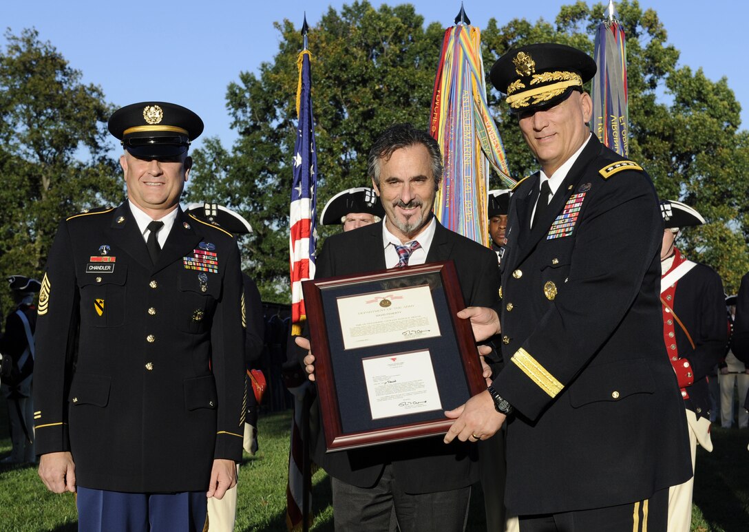 Army Chief of Staff Gen. Ray Odierno, left, and Sgt. Maj. of the Army Raymond F. Chandler III present the Outstanding Civilian Service Award to David Feherty during a ceremony in Joint Base Myer-Henderson Hall, Va., Oct. 11, 2012. Feherty received the award for his outstanding service to the Army, wounded warriors and their families as the co-founder of Feherty's Troops First Foundation.