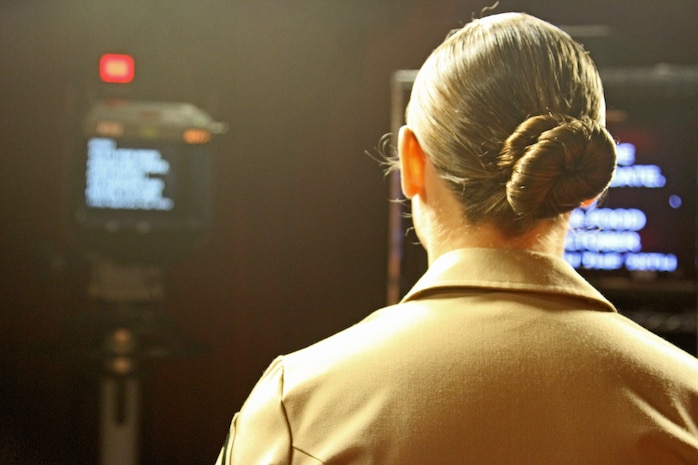 Lance Cpl. Amy Douglas, American Forces Network Broadcaster, delivers the news update inside the AFN building here Oct. 10, 2012. AFN delievers a live broadcast at the end of each month. They also host a live radio show daily.
