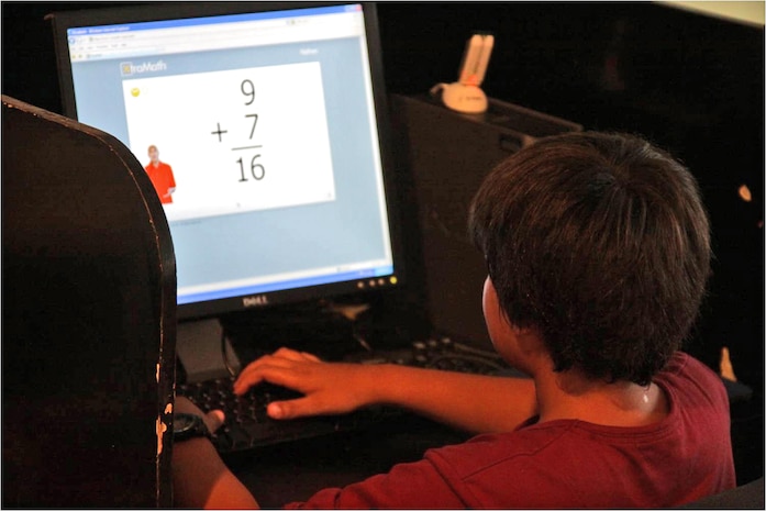 A Matthew C. Perry Elementary School student works on his homework during power hour at the Youth and Teen Center here Oct. 1, 2012. The goal of homework hour is to have students’ homework completed so that the student is adequately prepared for the next school day. The homework hour allows students extra time to finish tasks they may not have had time to complete during the school day.
