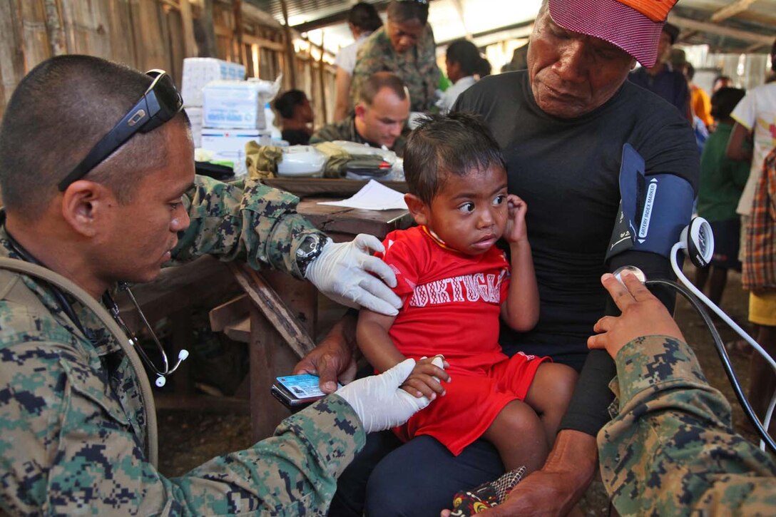 Petty Officer 2nd Class William Imperial, corpsman, Combat logistics Battalion 15, 15th Marine Expeditionary Unit gives a child a vaccine at a Timo-Leste village, Oct. 11, during Exercise Crocodilo 2012, the first exercise the 15th MEU and Peleliu Amphibious Ready Group has conducted during its Western Pacific deployment. During the exercise a total of 10 sights were visited in which corpsmen from the MEU  gave health screenings and vaccinations, made surgery referrals to a local hospital, provided dental care to include tooth removal, gave optometry screenings, prescribed and provided eyeglasses and issued medication and vitamins for minor illnesses or injuries. Imperial, 25, is from Manila, Philippines.