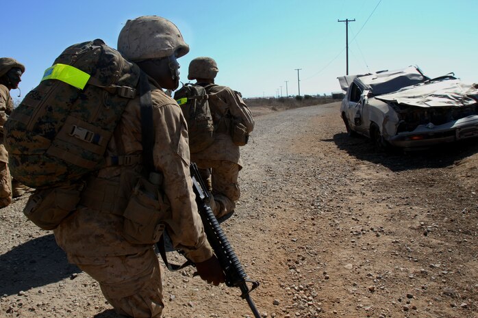 A recruit of Company M, 3rd Recruit Training Battalion, provides security during the John Quick trail, also known as Improvised Explosive Device lane, during recruit training aboard Edson Range, Marine Corps Base Camp Pendleton, Calif. Oct 2. Recruits immediately set up security when they came to a halt, usually when someone identified something suspicious along the trail.