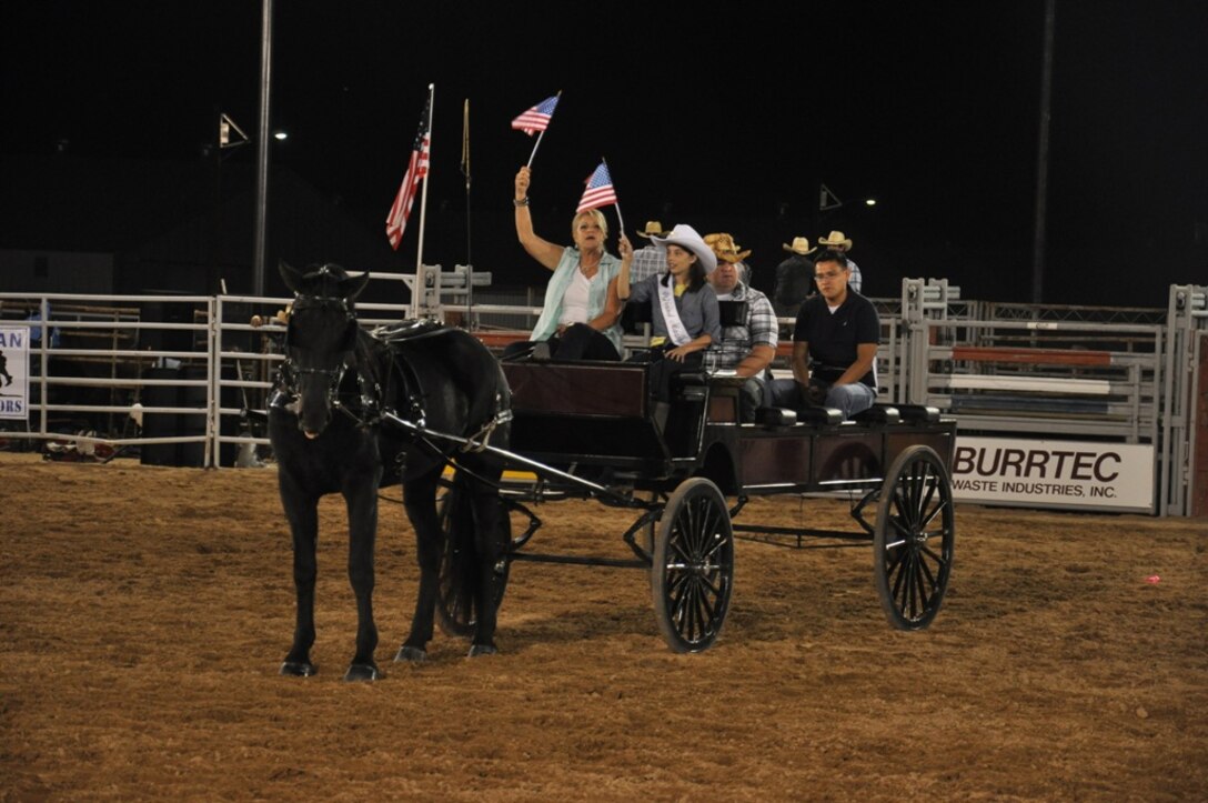 A horse-drawn carriage transports wounded warriors, service members who have been injured in combat zones, across the stables of Marine Corps Logistics Base Barstow Calif. as the crowd of the 2012 Barstow Rodeo Stampede applauds them for their service and sacrifice, Sept 28. The city of Barstow proclaimed the following day, Sept. 29, as Wounded Warrior Day.