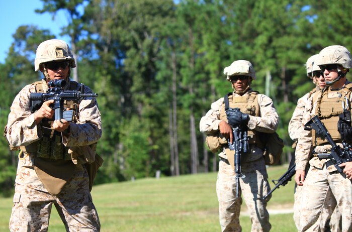 Chief Warrant Officer 2 Timothy E. Kessler, the platoon commander for Heavy Equipment Platoon, Engineer Company, Combat Logistics Regiment 2, demonstrates techniques for reloading under combat conditions during his unit’s pre-deployment  training aboard Camp Devil Dog, N.C., Oct. 11, 2012. The Marines practiced engaging targets rapidly in both day and night environments while wearing the gear they will employ in the field. 