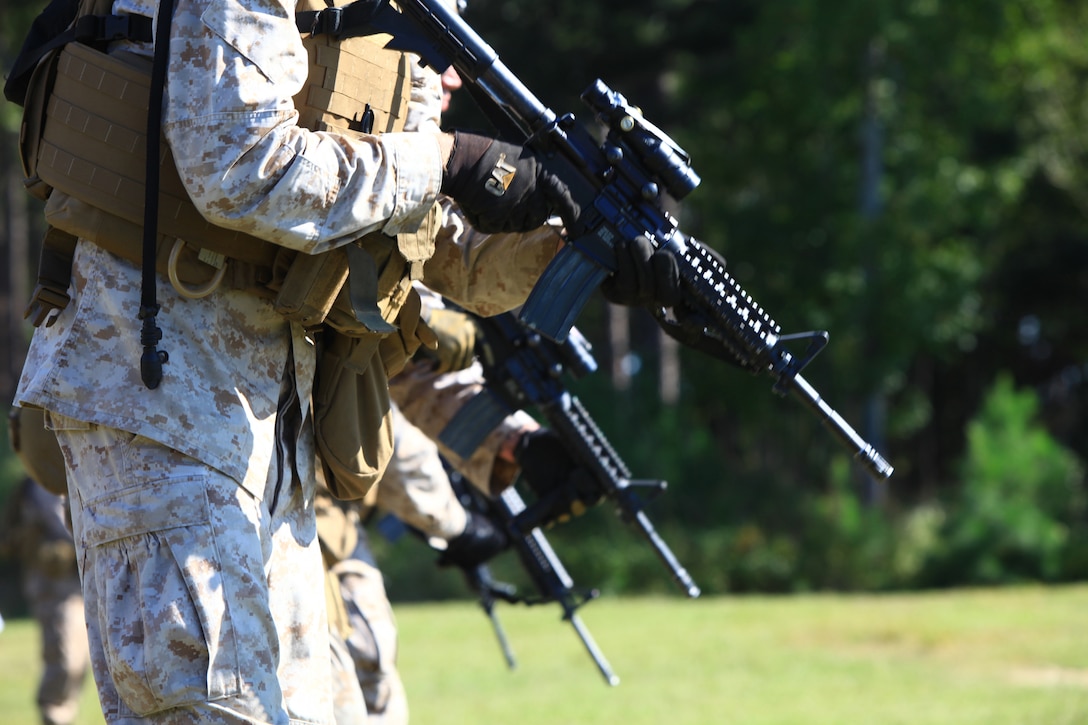 A line of Marines with Engineer Company, Combat Logistics Regiment 2, 2nd Marine Logistics Group stand poised to fire on targets during their pre-deployment training aboard Camp Devil Dog, N.C., Oct. 11, 2012. Approximately 50 Marines participated in the combat marksmanship training during two days of live-fire exercises that challenged their speed and precision in both day and night shooting exercises.