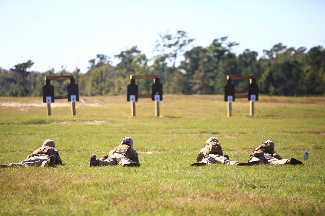 Four Marines with Engineer Company, Combat Logistics Regiment 2, 2nd Marine Logistics Group aim at their targets during the unit’s pre-deployment training aboard Camp Devil Dog, N.C., Oct. 11, 2012. The Marines adjusted the sights on their rifles prior to engaging man-shaped targets as part of a series of combat marksmanship exercises designed to test their ability to engage targets in day and night environments. 