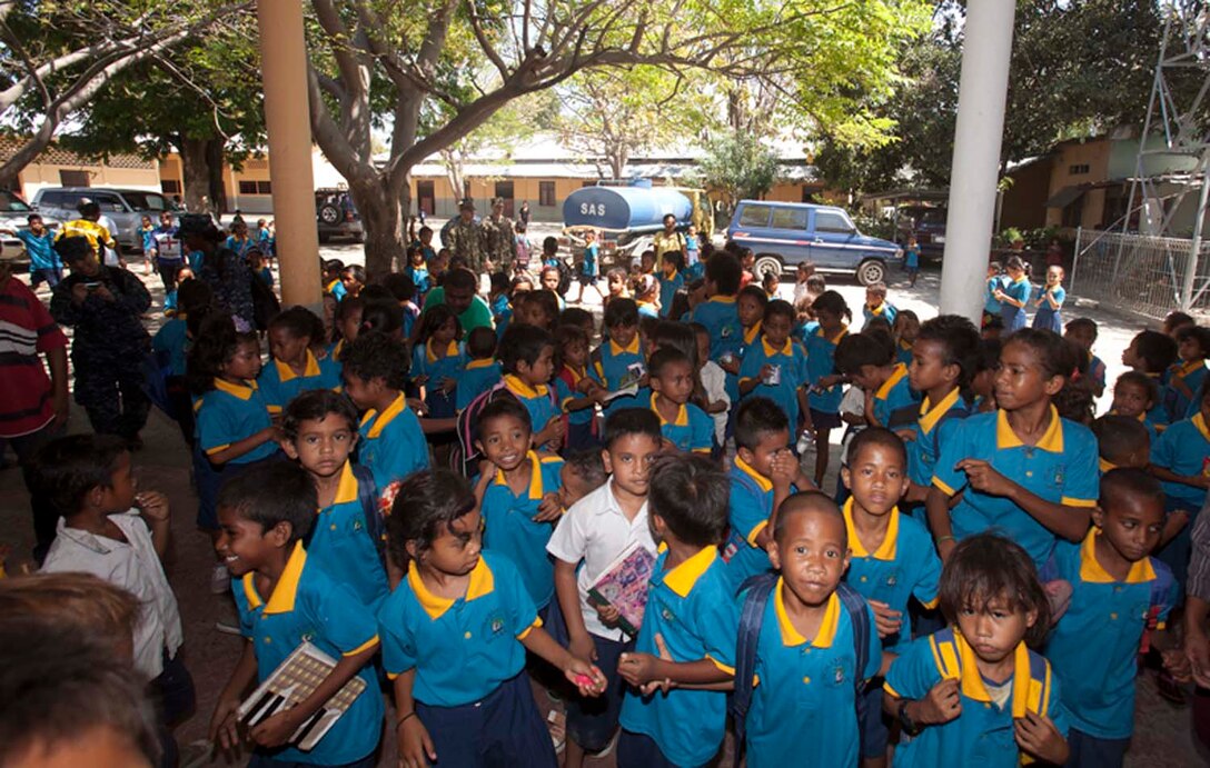 Children at Escola Primaria Nuu Laran in Dili, Timor-Leste wait for the 15th Marine Expeditionary Unit’s Religious Ministry Team to hand out donated sporting equipment and school supplies.  The MEU and the Peleliu Amphibious Ready Group are in the country conducting Exercise Crocodilo 12, a scheduled exercise to promote interoperability and cooperation between the US and Timor-Leste. 