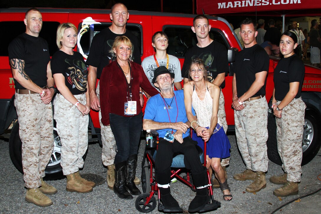 Marines with Recruiting Substation Mobile and Recruiting Station Montgomery stand beside Korean War veteran Freddy Powers and his family during the Bayfest Music Festival 6 October in Mobile, Alabama. Powers, a former Marine, is known for writing and playing songs with Willie Nelson, Big and Rich, and Merle Haggard.
