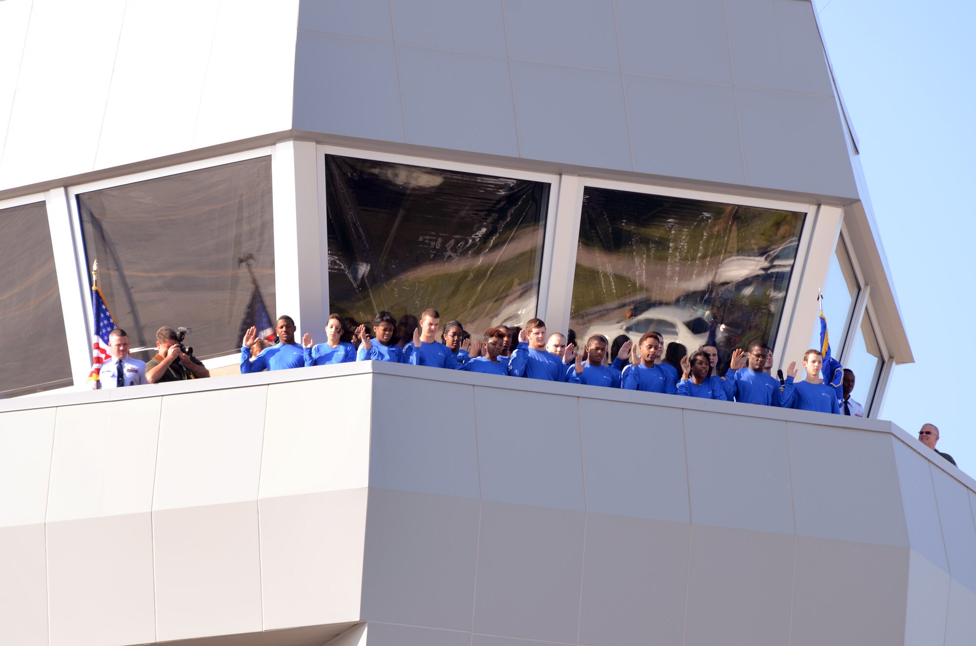 Col. Timothy E. Tarchick, 94th Airlift Wing commander, administers the the Oath of Enlistment to 19 future members of the U.S. Air Force Reserves atop of the Dobbins Air Reserve Base control tower during a mass enlistment ceremony Oct. 13. The ceremony was the first of its kind for Dobbins. (U.S. Air Force photo/Brad Fallin)