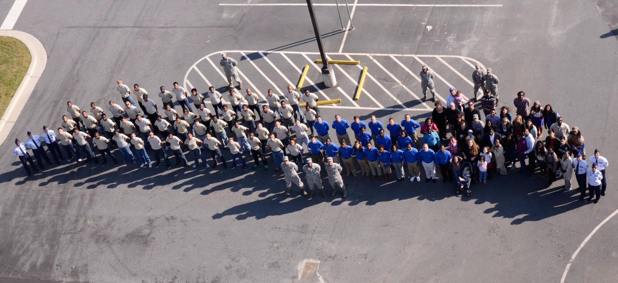 After taking the Oath of Enlistment at a mass enlistment ceremony atop of the Dobbins Air Reserve Base control tower, future U.S. Air Force Reservists join Col. Timothy E. Tarchick, 94th Airlift Wing commander, their families and friends, wing recruiters and members of the 94th Developement and Training Flight on the ground Oct. 13. The ceremony was the first of its kind for Dobbins. (U.S. Air Force photo/Don Peek)