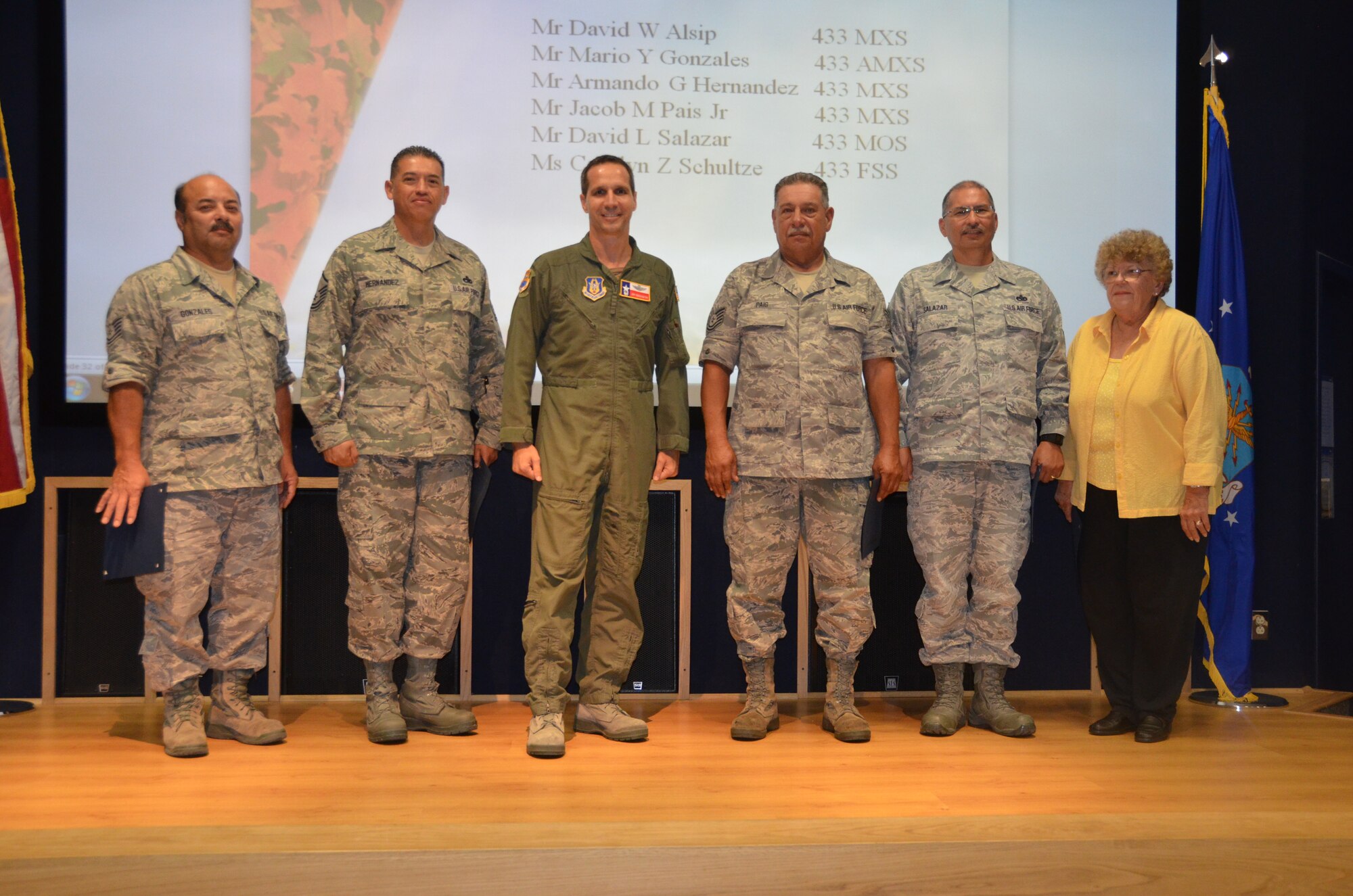 Col. Jeffrey Pennington, 433rd Airlift Wing commander recognizes several employees during a civilian commander’s call Oct 4, with service awards for their longevity as civil servants. (From left to right) Mario Gonzales,433rd AMXS; Armando Hernandez, 433rd MXS; Col. Jeffrey Pennington, 433rd AW commander; Jacob Pais Jr., 433rd MXS; David Salazar, 433rd MOS and Carolyn Schultze, 433rd FSS. (U.S. Air Force photo/SMSgt Minnie Jones)