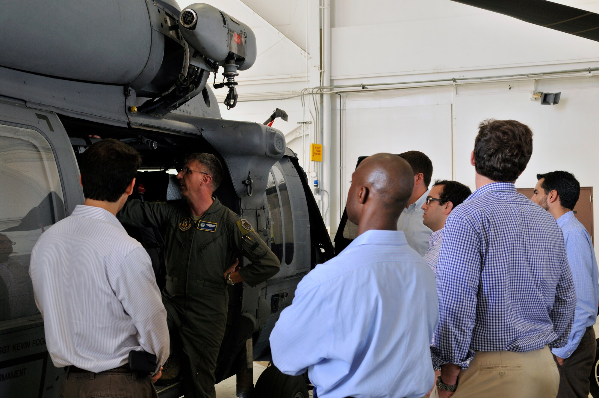 Col. Jeffrey Macrander, 920th Rescue Wing commander shows a HH-60G Pave Hawk rescue helicopter to congressional staffers who recently visited Patrick Air Force Base, Fla. The 920th RQW is a special operations wing and home to elite Guardian Angel Airmen who are among the most highly trained emergency trauma specialists in the U.S. military, and the only military personnel who are trained and equipped to conduct combat rescue for all of the other branches of the military. (U.S. Air Force photo/Tech. Sgt. Peter Dean) 
 
