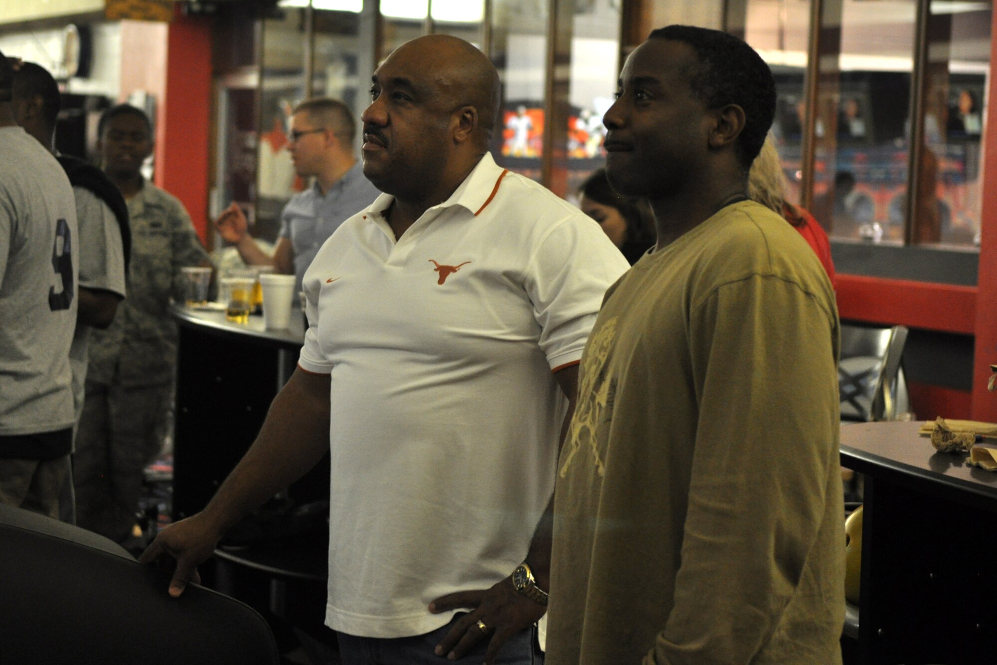 Tony Kendricks (left) and Tony Yarbrough looks on as their teammates post scores during the first of a three game elimination tournament at the Holiday Lanes in Bossier City, La., Oct. 12, 2012. Kendricks and Yarbrough were members of a team of bowlers from the 307th Bomb Wing at Barksdale Air Force Base, La., who competed in the tournament. The annual tournament is a continuation of the Celebrate Barksdale Picnic in appreciation of the Barksdale Military Community. Pizza and soft drinks were donated to the bowlers from a host of local business sponsors. The 307th BW team took 3rd Place overall in the tournament. (U.S. Air Force photo by Master Sgt. Jeff Walston/Released)