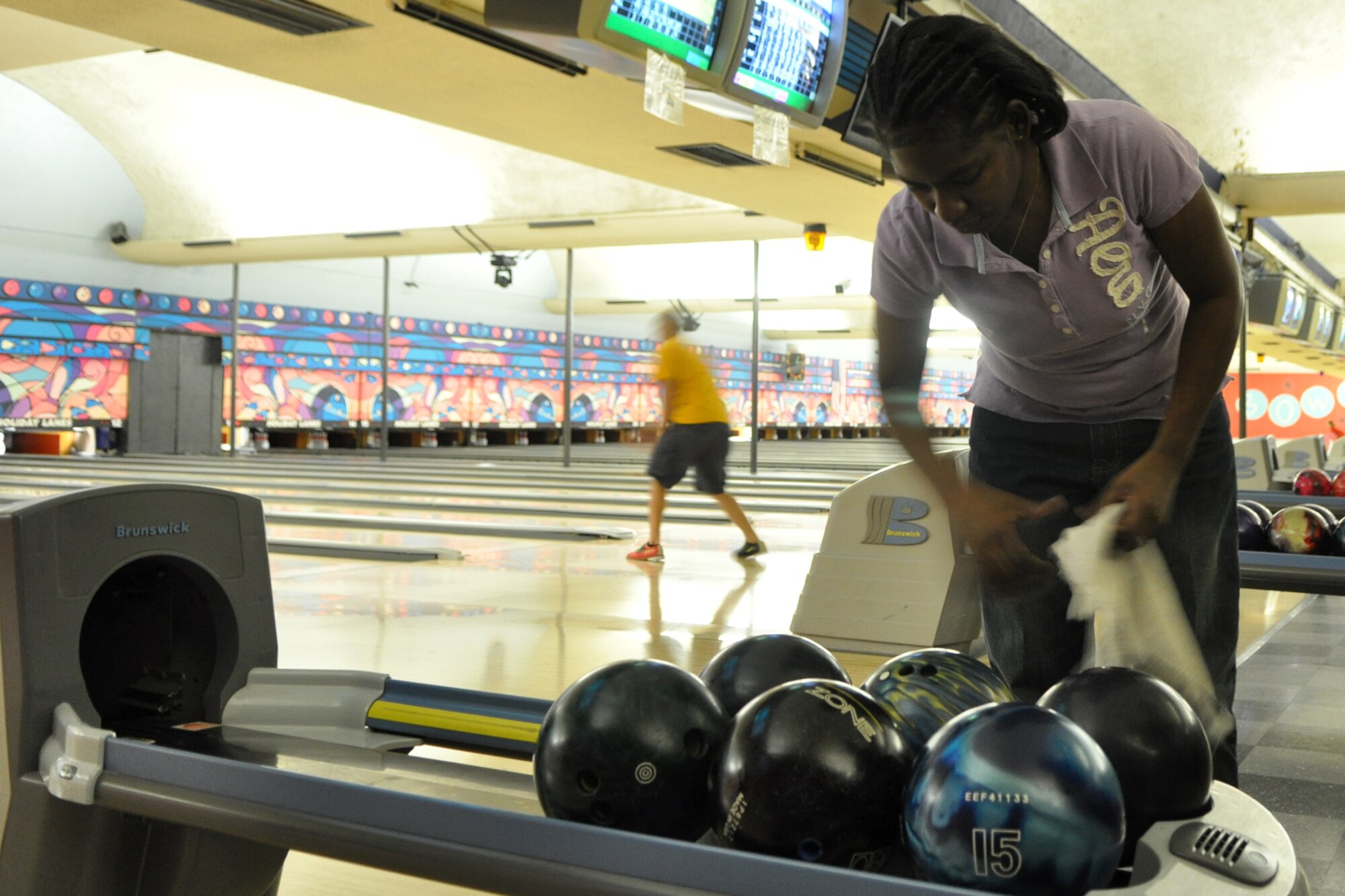 Shonda Long picks her ball during the first of a three game elimination tournament at the Holiday Lanes in Bossier City, La., Oct. 12, 2012. Long competed in the 3rd annual Members & Military Bowling Tournament sponsored by the Bossier Chamber of Commerce Business Members. The annual tournament is a continuation of the Celebrate Barksdale Picnic in appreciation of the Barksdale Military Community. Pizza and soft drinks were donated to the bowlers from a host of local business sponsors. The 307th BW team took 3rd Place overall in the tournament. (U.S. Air Force photo by Master Sgt. Jeff Walston/Released) 