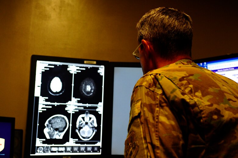 Maj. Samuel Southam, 455th Expeditionary Medical Dental Services Squadron radiologist at Bagram Air Field, looks at the images from Toor Pekai’s magnetic resonance imaging Oct. 1, 2012, assessing the damage caused by a stroke that happened approximately four months ago. Toor Pekai is the wife of Col. Amir Jan, Afghan Air Force staff judge advocate. . Amir Jan reached out through his coalition mentor to gain more insight into her condition. (Air Force photo by Staff Sgt. Melissa K. Mekpongsatorn)
