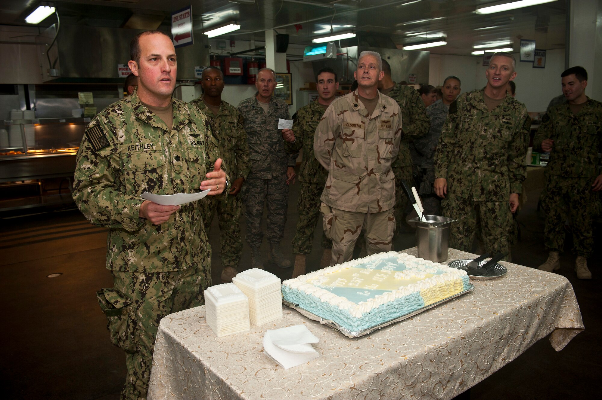 Left, Cmdr. Blair Keithley shares remarks about U.S. Navy heritage during a celebration at the Transit Center at Manas, Kyrgyzstan, Oct. 13, 2012. Joint service members celebrated the Navy's 237th birthday together at the Transit Center. Keithley is the U.S. Naval Forces Central Forward Headquarters officer in charge deployed from Joint Chiefs of Staff office, Washington D.C. (U.S. Air Force photo/Senior Airman Brett Clashman)