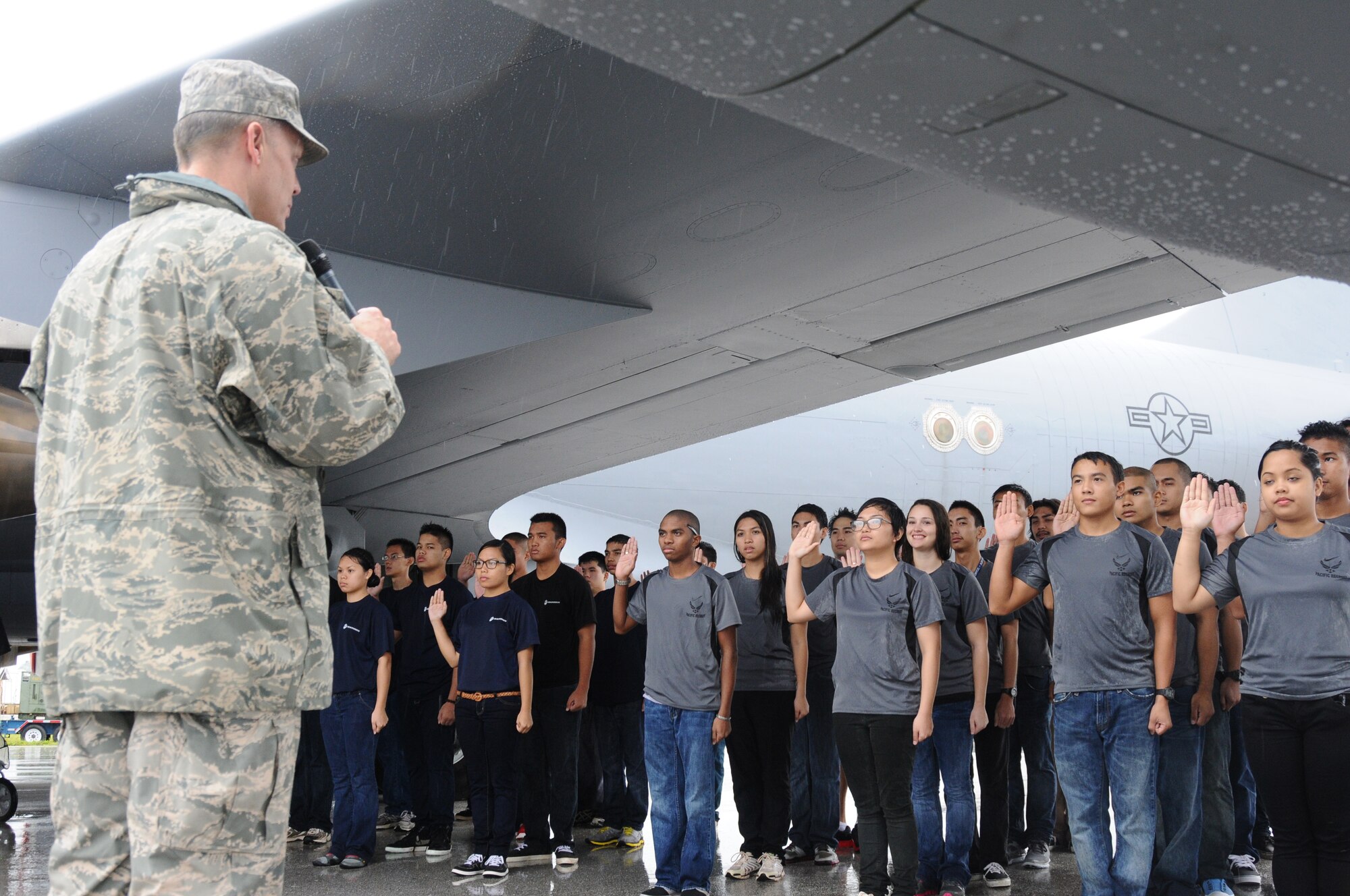 U.S. Air Force Brig. Gen.  Steven D. Garland, 36th Wing commander, administers the Oath of Enlistment to Air Force and Marine recruits underneath a KC-135 Stratotanker aircraft during the 2012 Andersen Air Force Base Open House in Guam Oct. 13.  This year’s open house is the first since 2009. (U.S. Air Force photo by Senior Airman Carlin Leslie/Released)