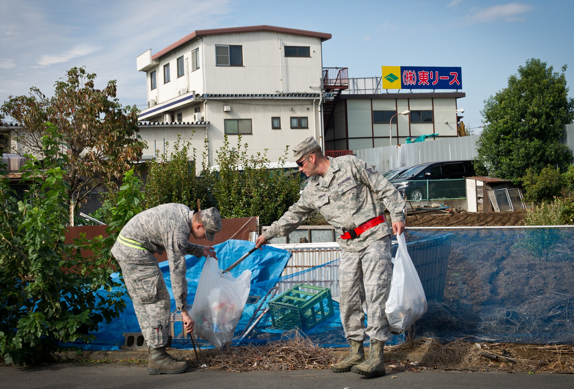 MIZUHO TOWN, Japan -- Master Sgt. Scott Hunkins, left, 374th Logistics Readiness Squadron fuels operation chief, and Airman 1st Class Joe Johnson, 374th Communications Squadron, right, collect trash around the local area of Mizuho, Japan, Oct. 11, 2012. The monthly clean-up gives Yokota Airmen a chance to get involved with the local community. (U.S. Air Force photo by Senior Airman Andrea Salazar)
