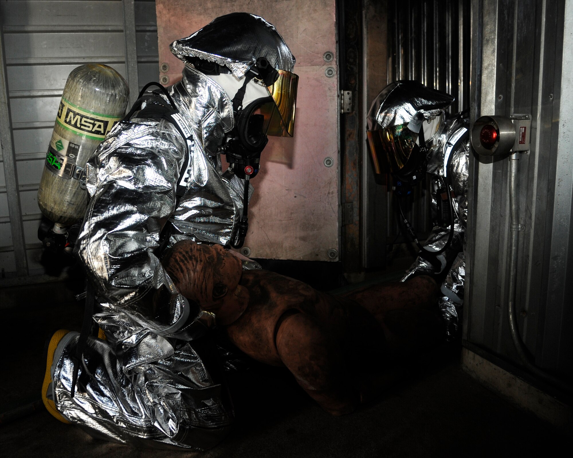 Members of 8th Fighter Wing leadership drag out a 180-pound rescue dummy from a building during fire safety week at Kunsan Air Base, Republic of Korea, Oct. 12, 2012. Responders had to stay low to avoid the heat and smoke from the simulated fire. (U.S. Air Force photo/Senior Airman Marcus Morris)