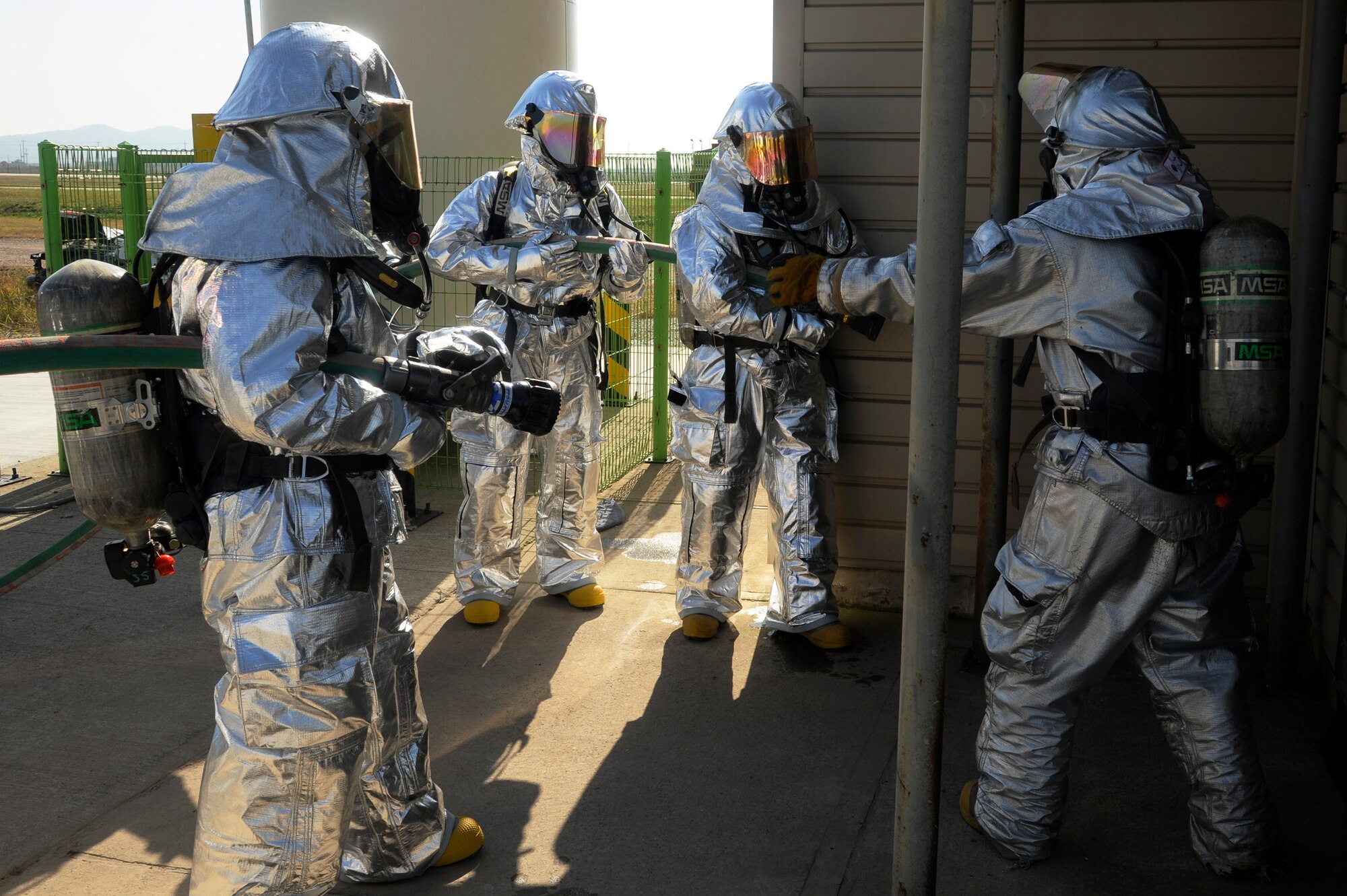 Members of 8th Fighter Wing leadership prepare to enter a simulated burning building during fire safety week at Kunsan Air Base, Republic of Korea, Oct. 12, 2012. The officers were challenged to take, just like the firefighters, only one minute to don their gear and get into the response vehicles for the fire. (U.S. Air Force photo/Senior Airman Marcus Morris)