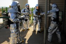 Members of 8th Fighter Wing leadership prepare to enter a simulated burning building during fire safety week at Kunsan Air Base, Republic of Korea, Oct. 12, 2012. The officers were challenged to take, just like the firefighters, only one minute to don their gear and get into the response vehicles for the fire. (U.S. Air Force photo/Senior Airman Marcus Morris)