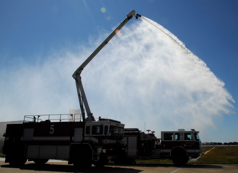 Members of the 8th Civil Engineer Squadron firefighters, demonstrate the capabilities of the crash response vehicle during fire safety week at Kunsan Air Base, Republic of Korea. Oct. 11, 2012. The vehicles have a 75-foot ladder and the smaller models can hold 750 gallons of water. (U.S. Air Force photo/Senior Airman Marcus Morris)