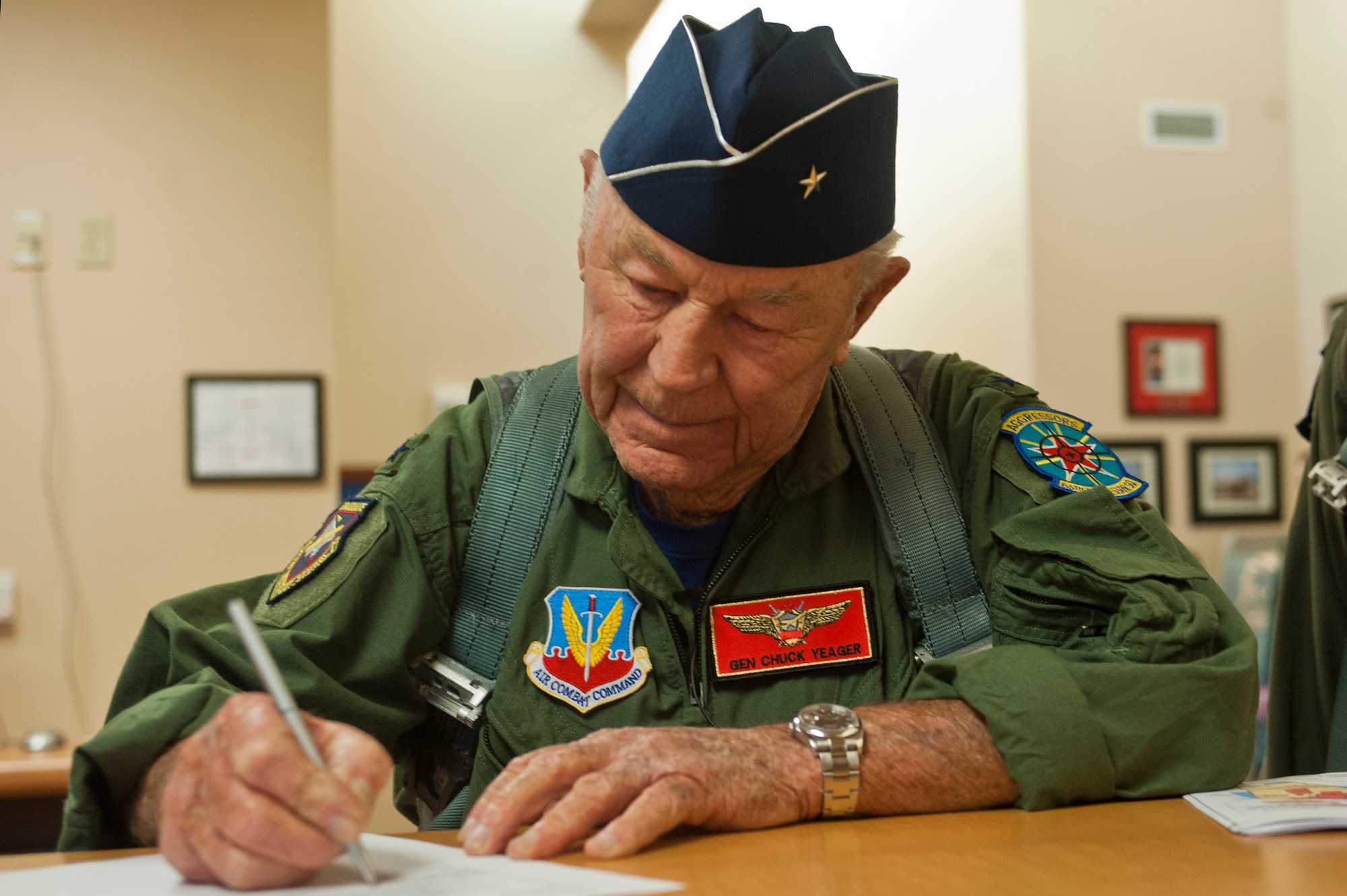 Retired United States Air Force Brig. Gen. Charles E. "Chuck" Yeager signs out from the 65th Aggressor Squadron after his pre-flight briefing Oct. 14, 2012, at Nellis Air Force Base, Nev. Yeager became the first pilot to break the sound barrier in 1947, and broke it again age 89 in an F-15D Eagle from the 65th AGRS. (U.S. Air Force photo by Airman 1st Class Jason Couillard)

