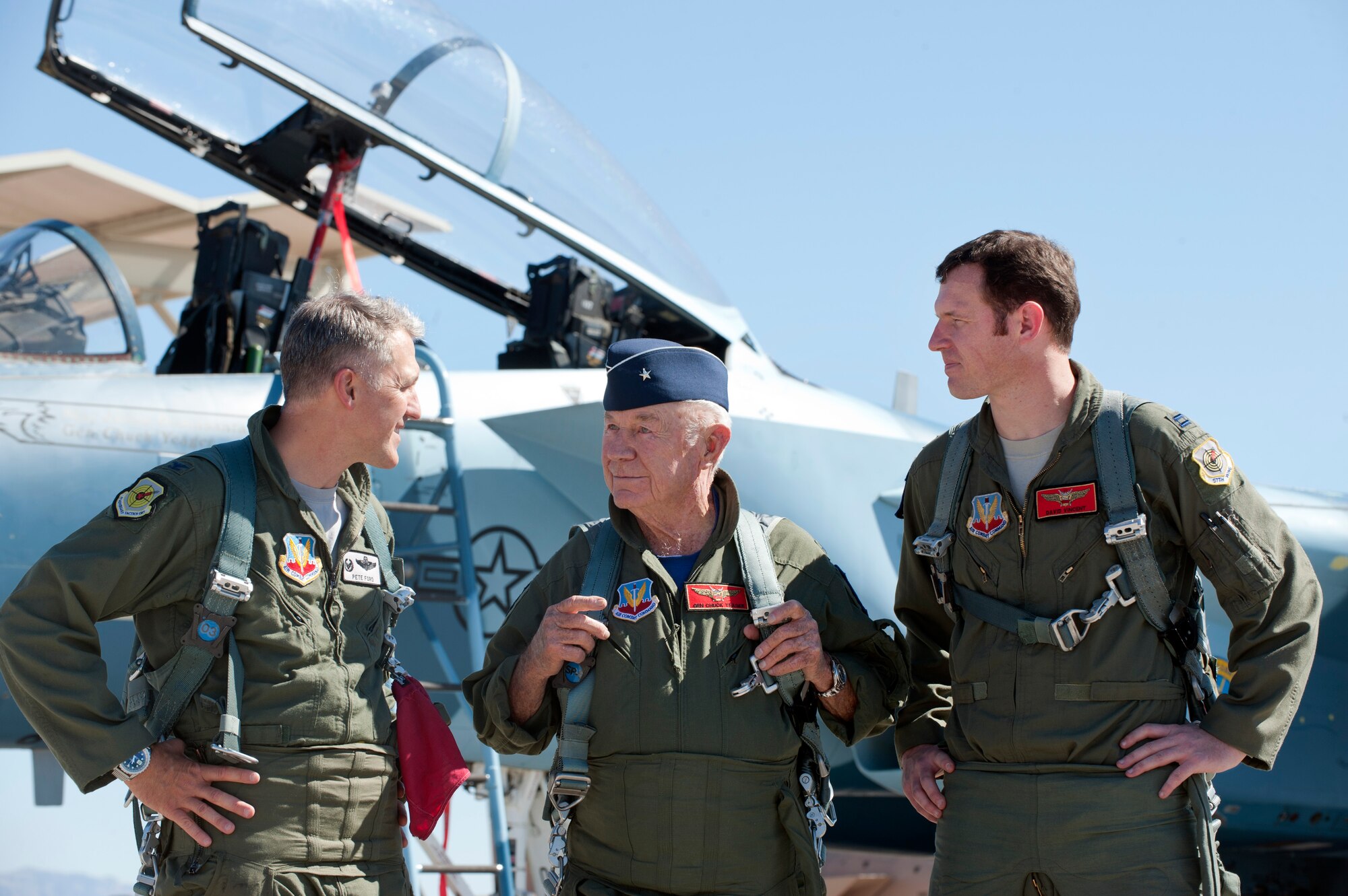 Col. Peter Ford, Adversary Tactics Group commander; retired United States Air Force Brig. Gen. Charles E. "Chuck" Yeager; and Capt. David Vincent, 65th Aggressor Squadron pilot, talk after Yeager's 65th anniversary commemoration flight landed at Nellis Air Force Base, Nev., Oct. 14, 2012.  Yeager flew in a 65th AGRS F-15D Eagle to mark his historic flight in the Bell X-1 rocket research plane. (U.S.Air Force photo by Lawrence Crespo)