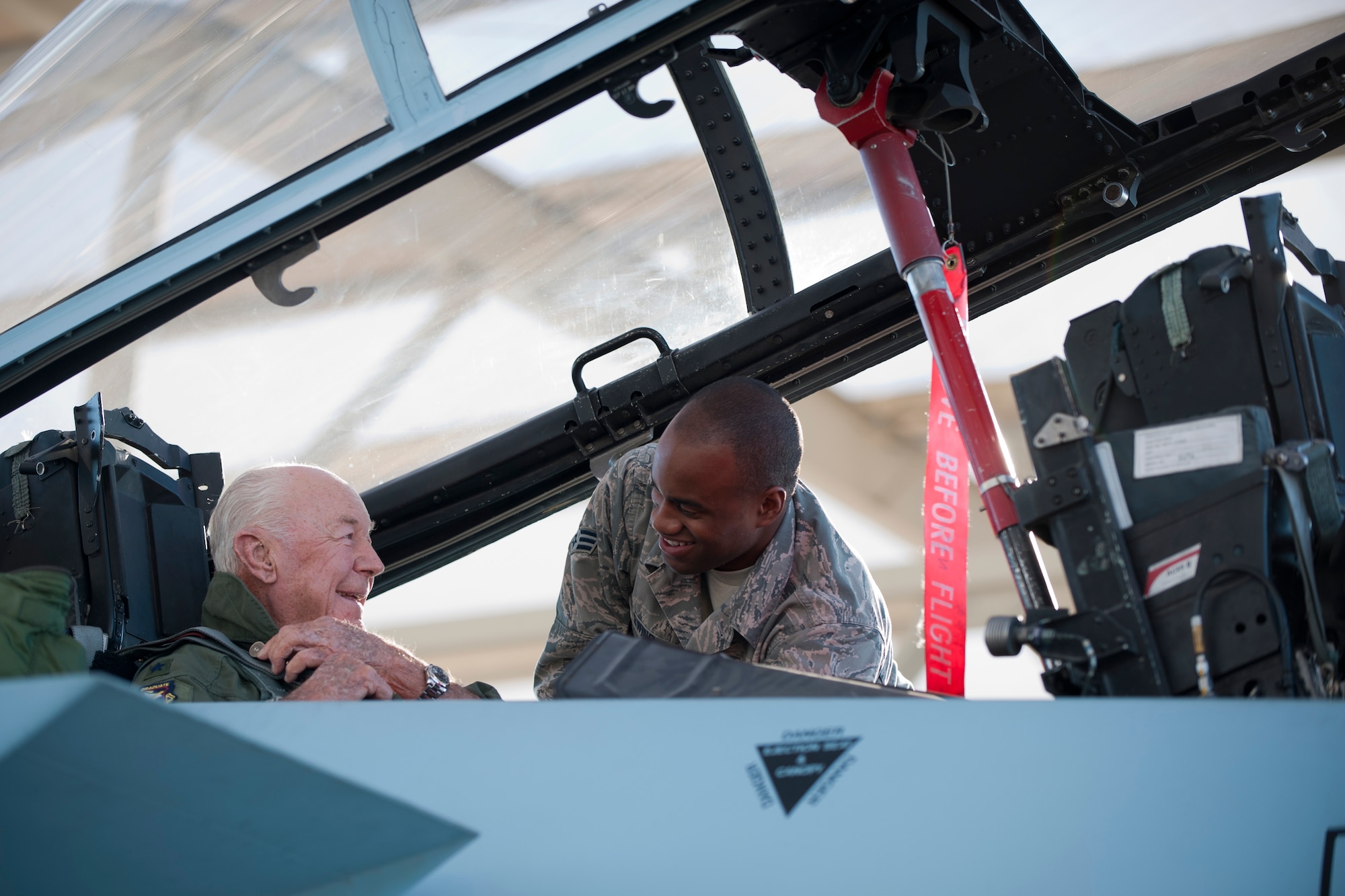 Retired United States Air Force Brig. Gen. Charles E. "Chuck" Yeager is assisted in the cockpit of an F-15D Eagle by by Senior Airman Anthony Ewing, 757th Aircraft Maintenance Squadron dedicated crew chief, Oct. 14, 2012, at Nellis Air Force Base, Nev. Yeager was commemorating  the 65th anniversary of his breaking of the sound barrier flying with the 65th Aggressor Squadron. (U.S. Air Force photo by Lawrence Crespo)