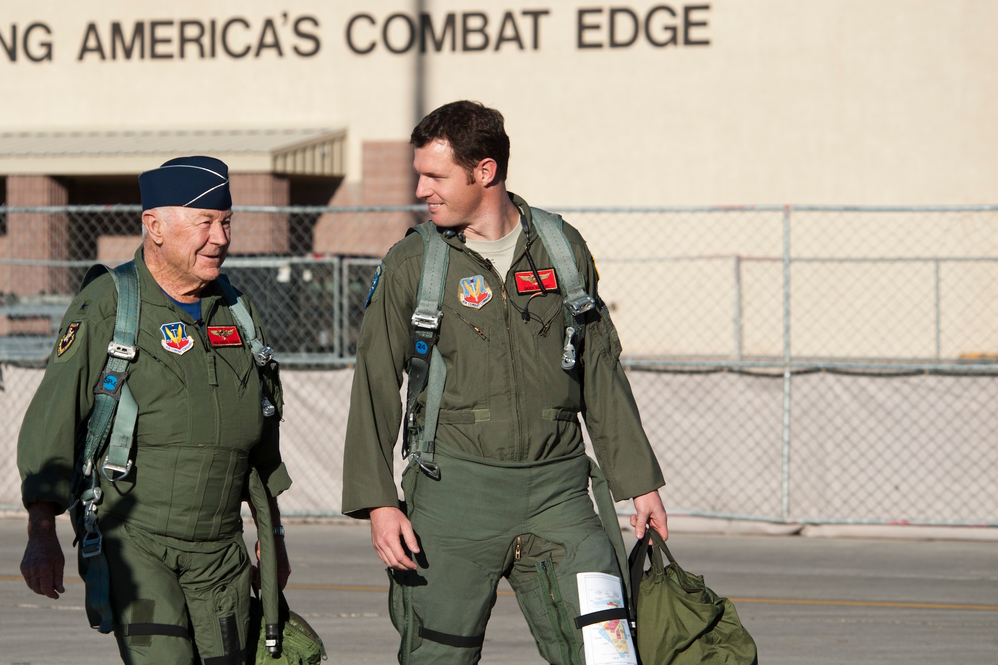 Retired United States Air Force Brig. Gen. Charles E. "Chuck" Yeager and Capt. David Vincent, 65th Aggressor Squadron pilot, walk to an F-15D Eagle Oct. 14, 2012, at Nellis Air Force Base, Nev. Yeager and Vincent commemorated the 65th anniversary of breaking of the sound barrier by flying from Las Vegas to Edwards AFB in southern California. (U.S. Air Force photo by Lawrence Crespo)