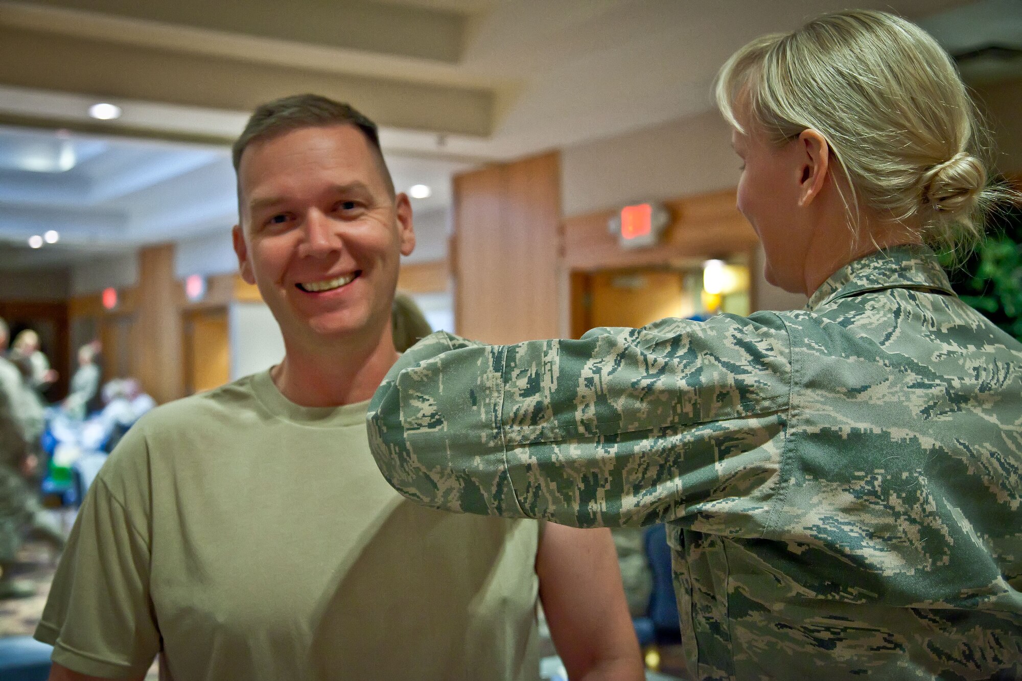 Lt. Col. Ted Ruminsky, 934th Security Forces Squadron commander, is given his flu shot by Maj. Julianna Olson, 934th Aeromedical Staging Squadron.   Leadership of the 934 AW lined up to get their annual flu vaccines before the pre-Unit Training Assembly meeting Thursday evening at the Minneapolis-St. Paul Air Reserve Station, Minn.  (U.S. Air Force Photo/Shannon McKay)