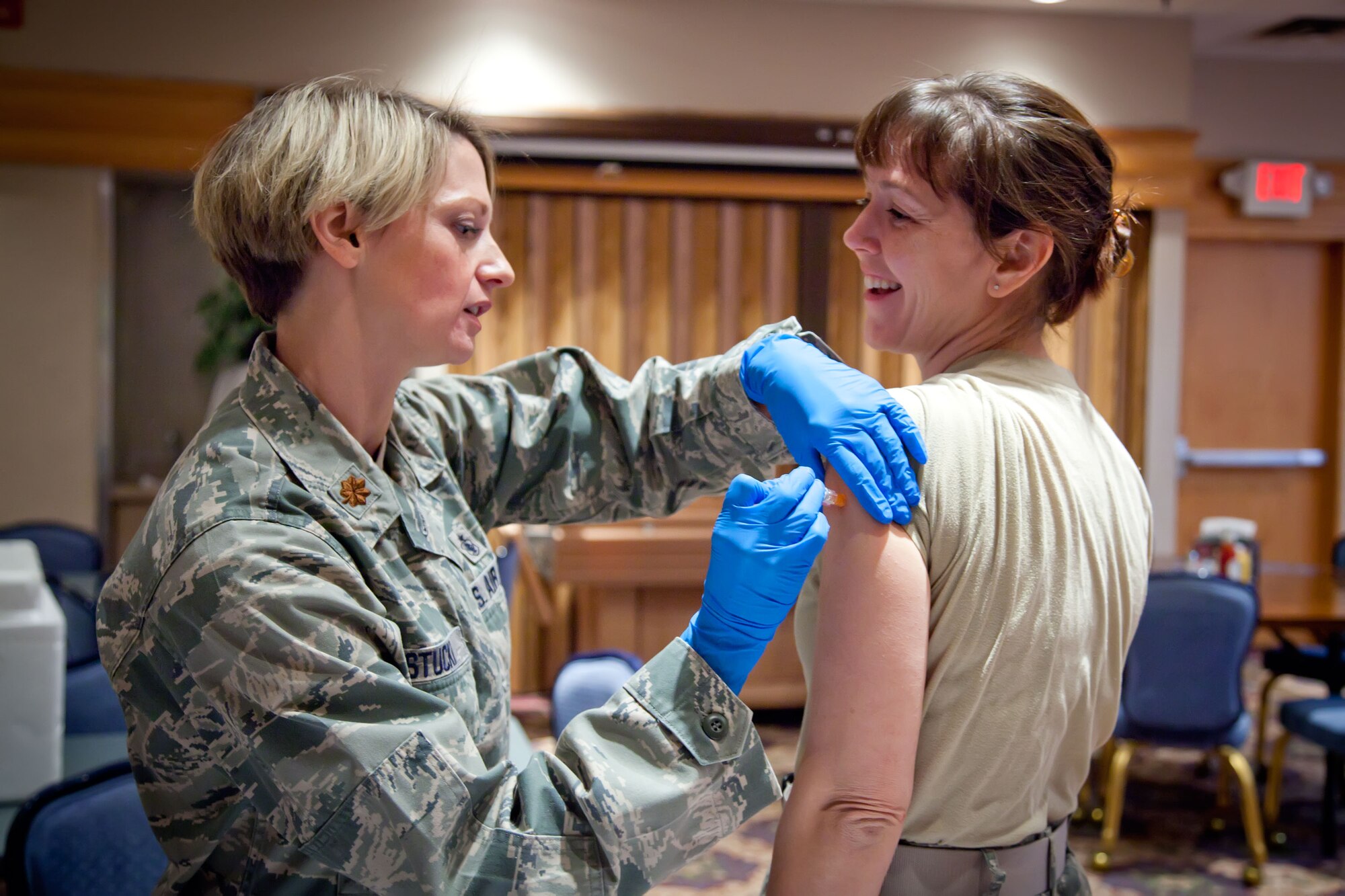 Maj. Sabra Brown, 934th Airlift Wing Chief of Public Affairs, is given her flu shot by Maj. Alexis Stucki, 934th Aeromedical Evacuation Squadron.   Leadership of the 934 AW lined up to get their annual flu vaccines before the pre-Unit Training Assembly meeting Thursday evening at the Minneapolis-St. Paul Air Reserve Station, Minn.  (U.S. Air Force Photo/Shannon McKay)