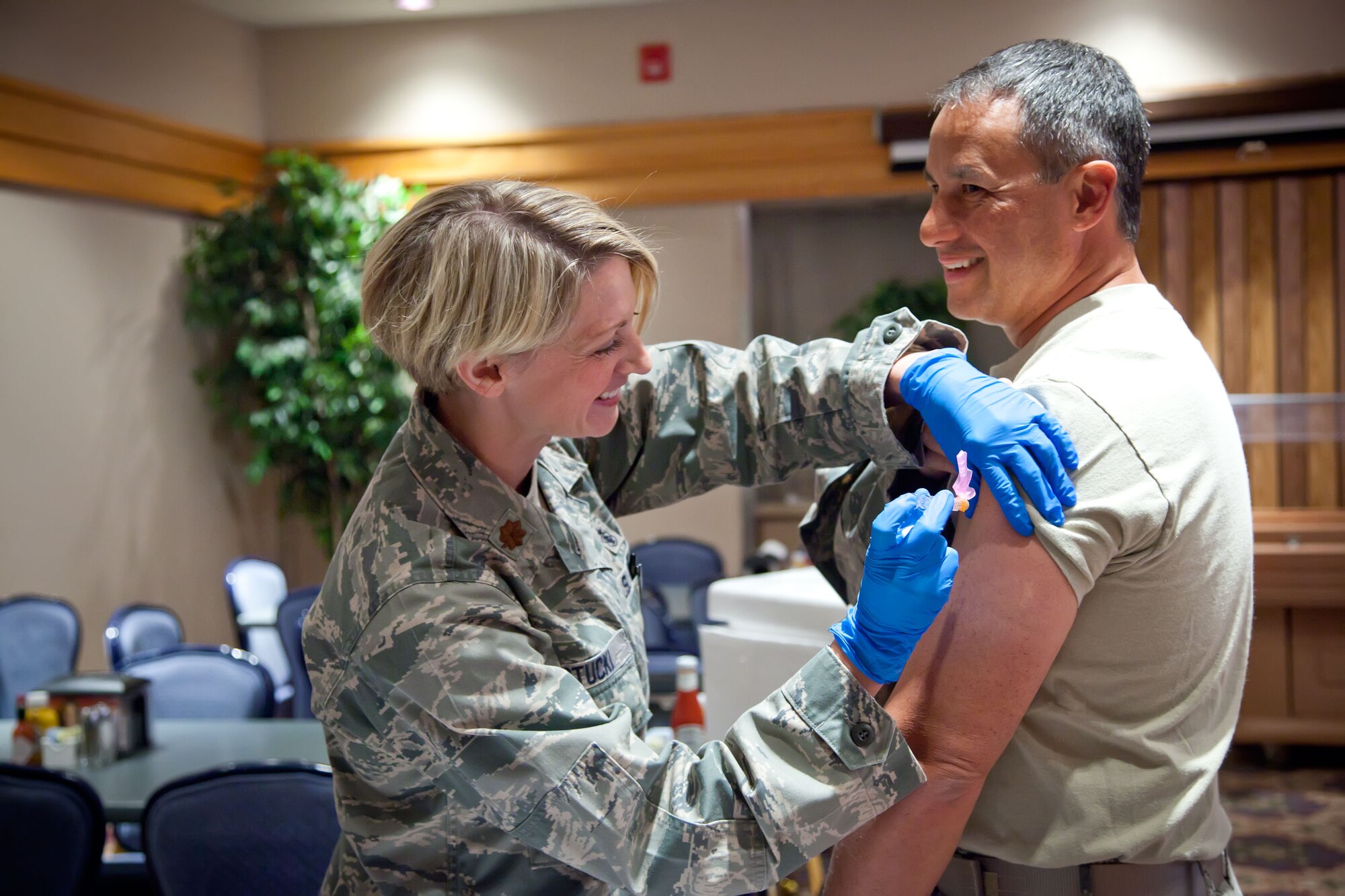 Col. Todd McCubbin, Vice-Commander of the 934th Airlift Wing, is given his flu shot by Maj. Alexis Stucki, 934th Aeromedical Evacuation Squadron.   Leadership of the 934 AW lined up to get their annual flu vaccines before the pre-Unit Training Assembly meeting Thursday evening at the Minneapolis-St. Paul Air Reserve Station, Minn.  (U.S. Air Force Photo/Shannon McKay)