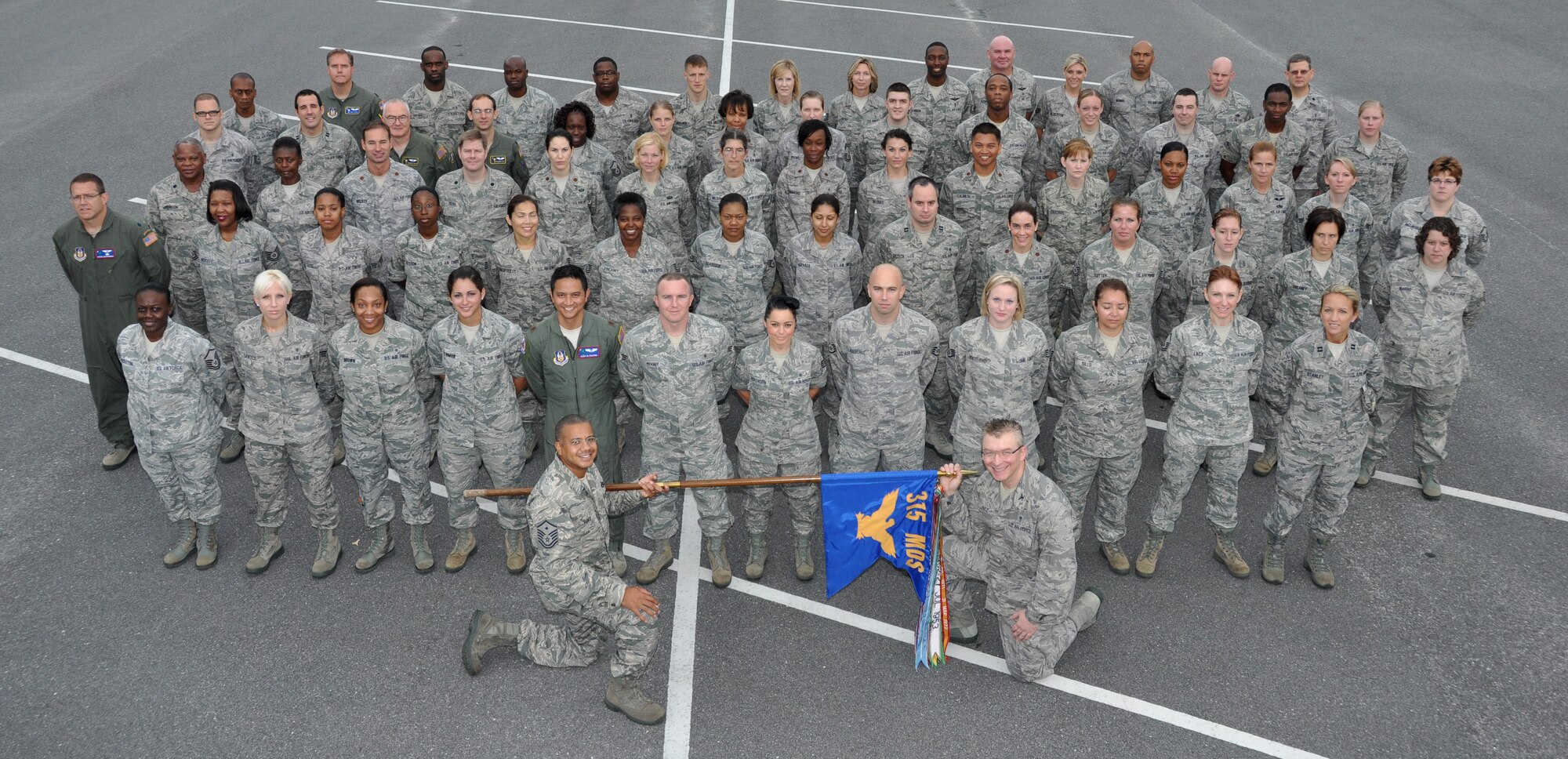 Members of the 315th Aerospace Medicine Squadron pose for a picture with the squadron guidon at Joint Base Charleston, S.C. U.S. Air Force photo by SrA. Bobby Pilch.