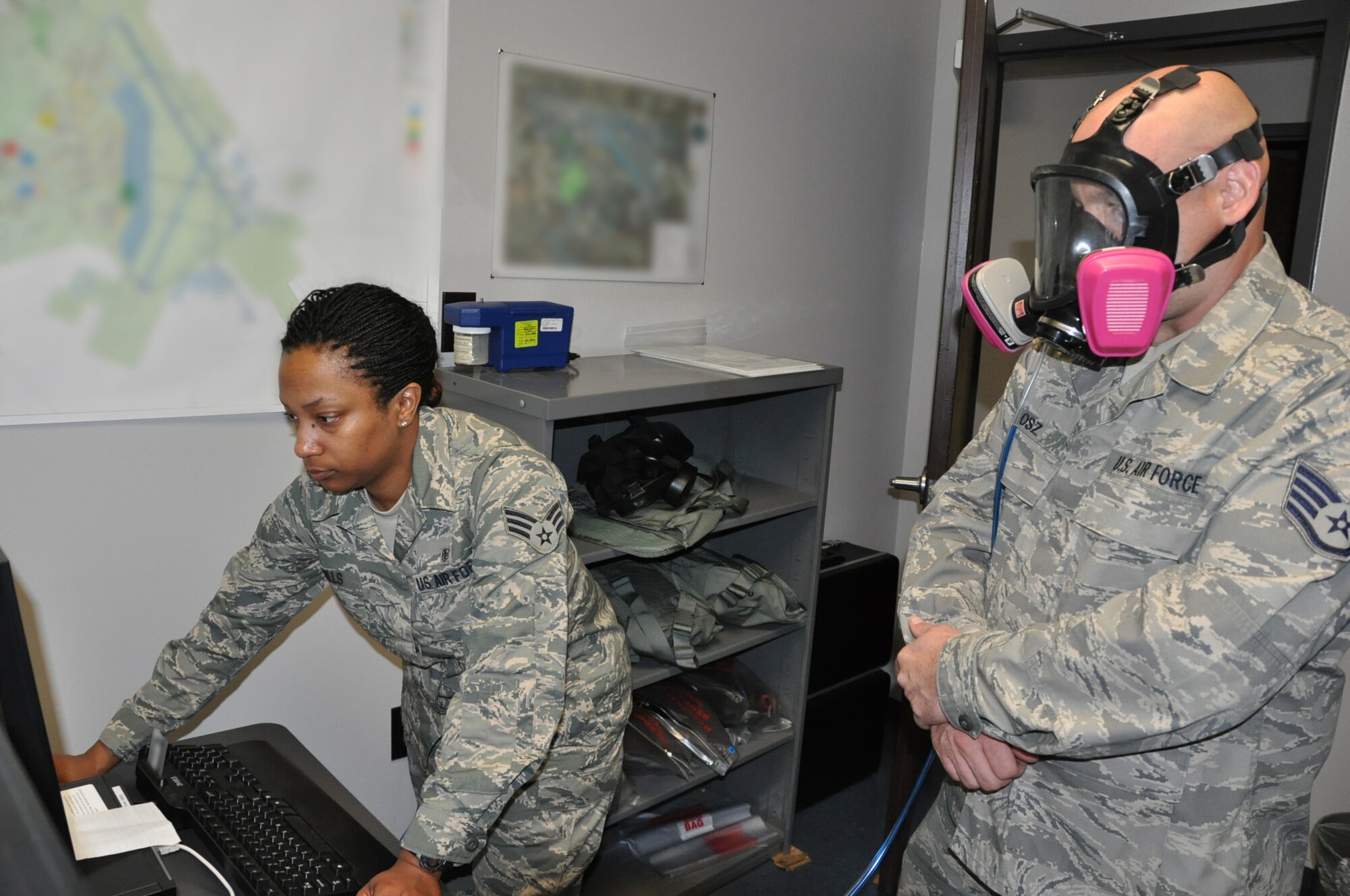 Senior Airman Ebony T. Hills, a bioenvironmental  journeyman assigned to the 315th Airlift Wing Aerospace Medicine Squadron, performs a gas mask fit test on Staff Sgt. Shawn H. Osz, an aircraft fuel systems specialist with the 315 AW Maintenance Squadron here at Joint Base Charleston, Air Base, S.C., October 14, 2012.  Hills was selected as the MAJCOM 2011 Outstanding Bioenvironmental Engineering Airman of the Year. Sections of this photo were blurred for security purposes. U.S. Air Force photo by SrA. Bobby Pilch.