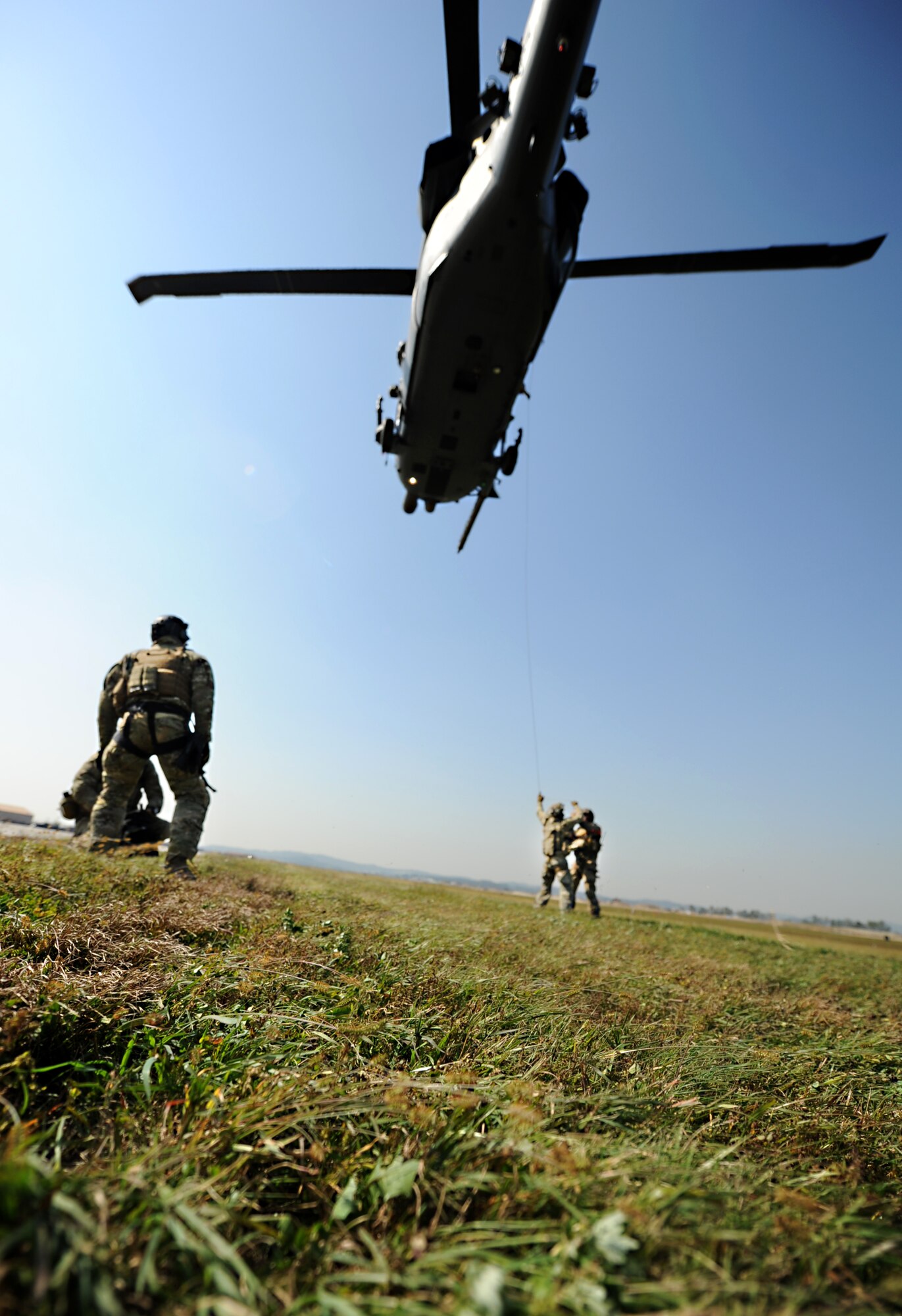 A combat rescue officer and three 31st Rescue Squadron pararescuemen perform alternate insertions and extractions from a 33rd Rescue Squadron HH-60 Pave Hawk during a combat search and rescue training scenario for Exercise Pacific Thunder at Osan Air Base, Republic of Korea, Oct. 12, 2012. Pacific Thunder is an annual two-week exercise that links up 31st and 33rd Rescue Squadron Airmen with the 25th Fighter Squadron and other units at Osan AB, to test CSAR tactics to prepare for real-world emergency situations. (U.S. Air Force photo/Staff Sgt. Sara Csurilla)