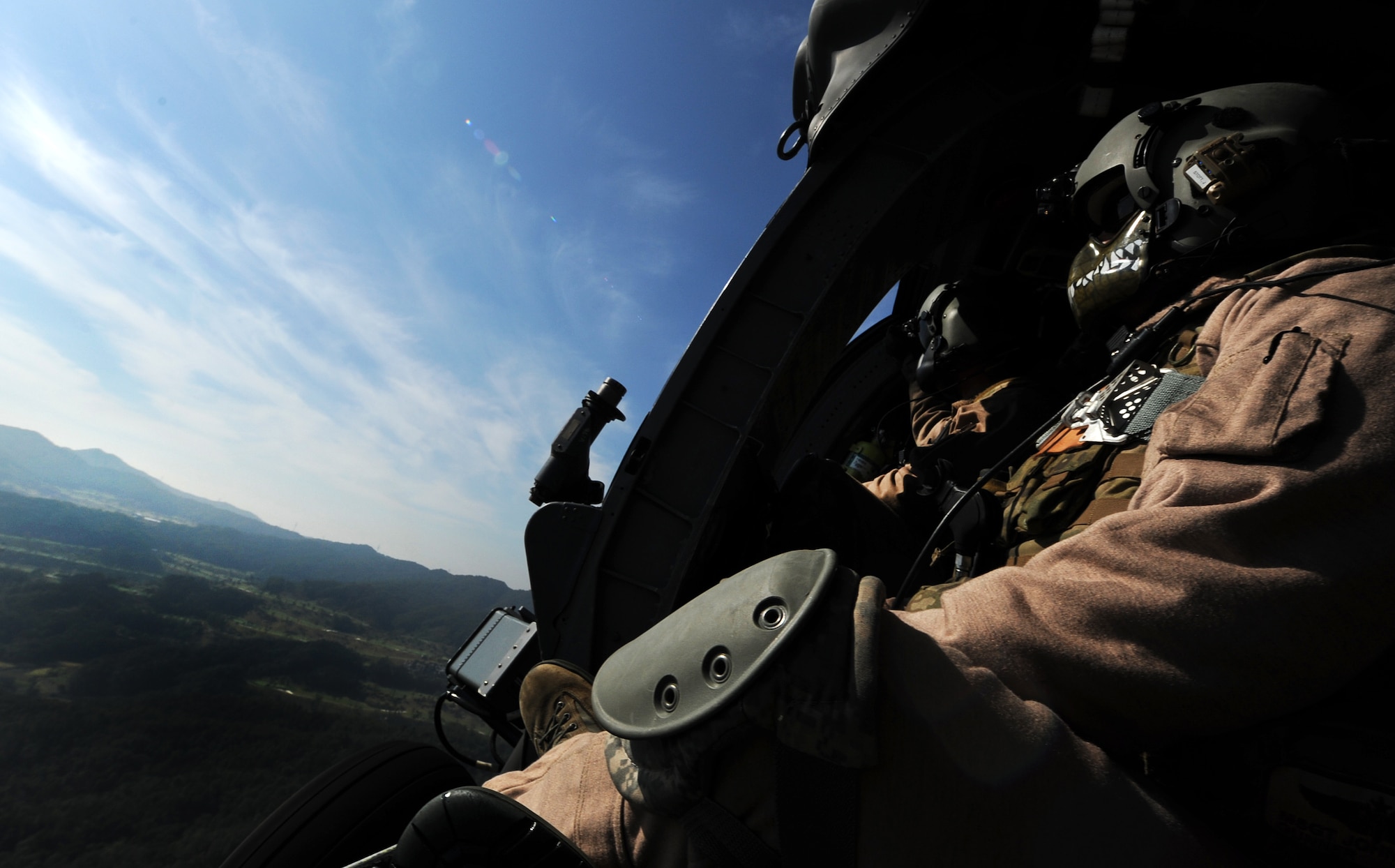 Master Sgt. John Stott, 33rd Rescue Squadron superintendent and aerial gunner, sits on the edge of an HH-60 Pave Hawk during a combat search and rescue training scenario for Exercise Pacific Thunder at Osan Air Base, Republic of Korea, Oct. 12, 2012. Pacific Thunder is an annual two-week exercise where members of the 33rd and 31st Rescue Squadrons met up with the 25th Fighter Squadron and multiple other units at Osan AB, to test CSAR tactics to prepare for real-world emergency situations. (U.S. Air Force photo/Staff Sgt. Sara Csurilla)