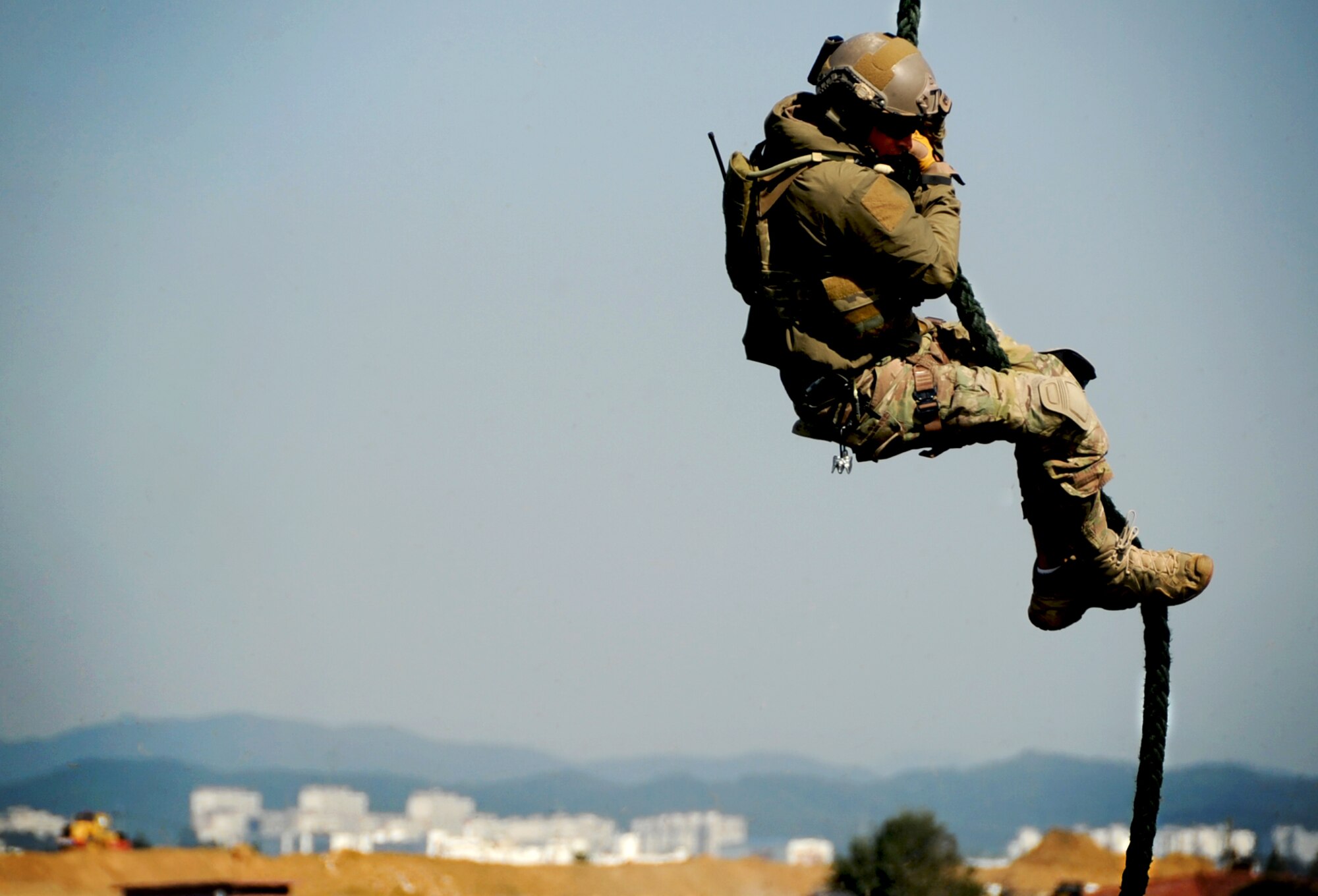 A 31st Rescue Squadron pararescueman performs alternate insertions and extractions from a 33rd Rescue Squadron HH-60 Pave Hawk during a combat search and rescue training scenario for Pacific Thunder at Osan Air Base, Republic of Korea, Oct. 12, 2012. Pacific Thunder is an annual two-week exercise where members of the 31st and 33rd Rescue Squadrons met up with the 25th Fighter Squadron and other units at Osan AB, to test CSAR tactics to prepare for real-world emergencies. (U.S. Air Force photo/Staff Sgt. Sara Csurilla)