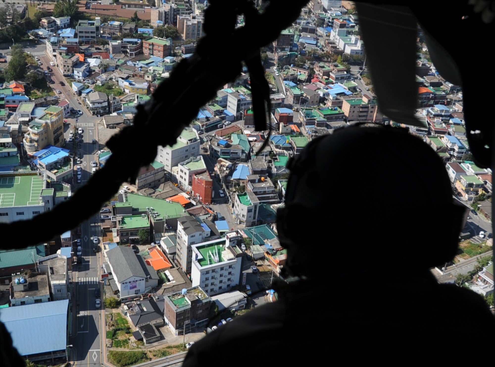 Master Sgt. John Stott, 33rd Rescue Squadron superintendent and aerial gunner, sits on the edge of an HH-60 Pave Hawk during a combat search and rescue training scenario for Pacific Thunder 2012 at Osan Air Base, Republic of Korea, Oct. 12, 2012. Pacific Thunder is an annual two-week exercise where members of the 33rd and 31st Rescue Squadrons met up with the 25th Fighter Squadron and multiple other units at Osan AB, to test CSAR tactics to prepare for real-world emergency situations. (U.S. Air Force photo/Staff Sgt. Sara Csurilla)