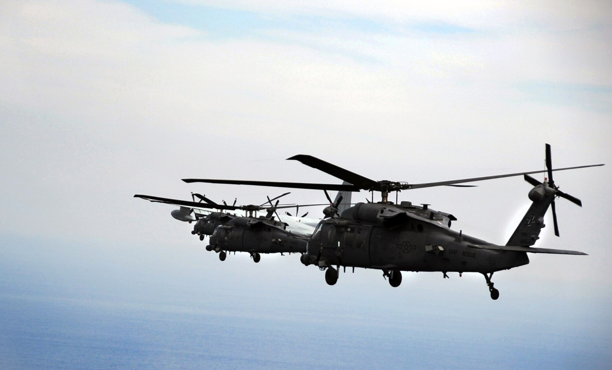 Three HH-60 Pave Hawks from the 33rd Rescue Squadron at Kadena Air Base, Japan, travel from Kadena to Osan Air Base, Republic of Korea, Oct. 10, 2012. The 33rd and 31st RQSs traveled to Osan to team up with the 25th Fighter Squadron to participate in PACIFIC THUNDER 2012. Pacific Thunder is an annual two-week exercise at Osan AB to test combat search and rescue tactics to prepare for real-world emergencies. (U.S. Air Force photo/Staff Sgt. Sara Csurilla)